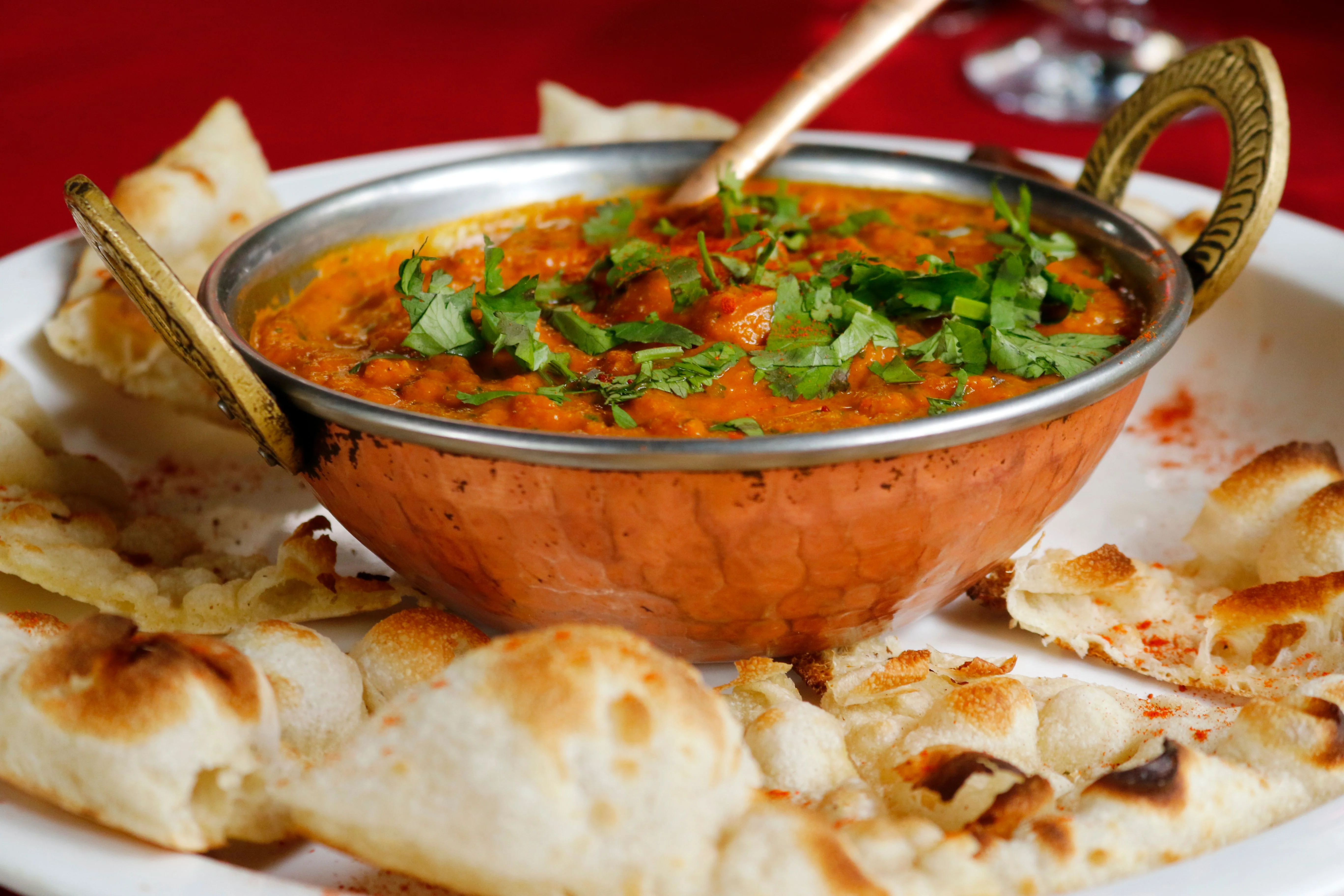 Rich Indian butter chicken served with naan bread