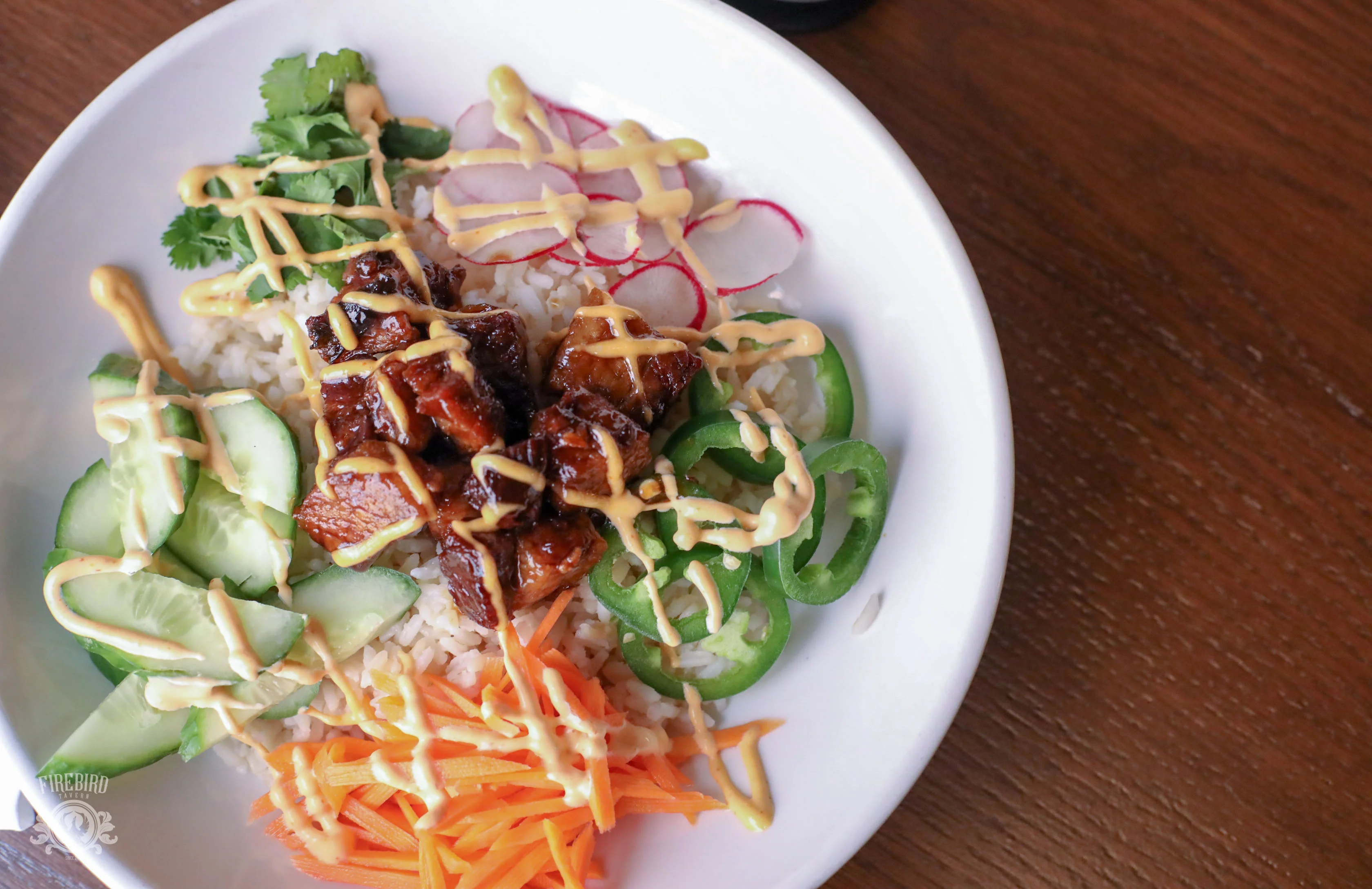 Korean rice bowl with grilled chicken and fresh vegetables
