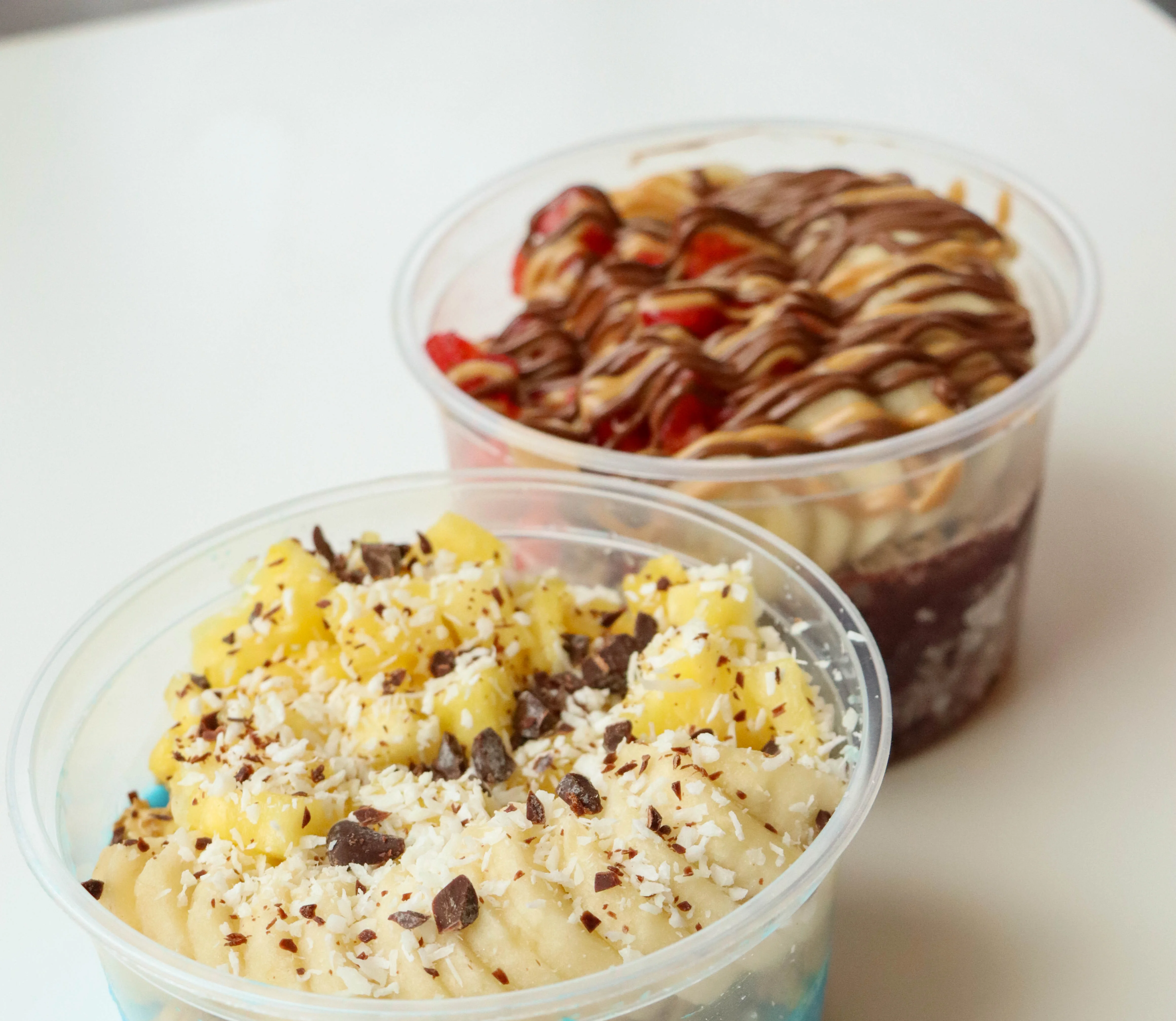 A laker acai bowl and a nutty buddy acai bowl