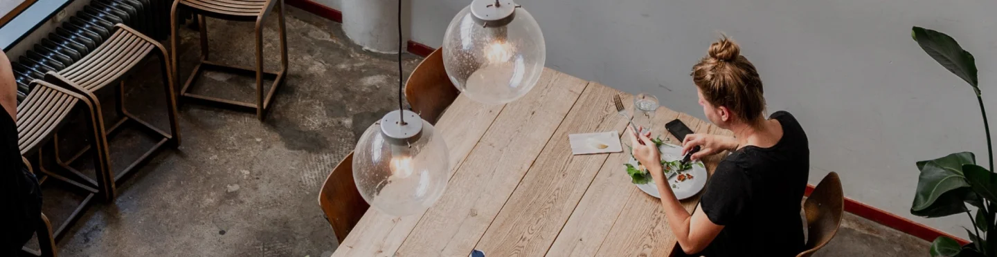 Cozy restaurant dining area with wooden table and pendant lights