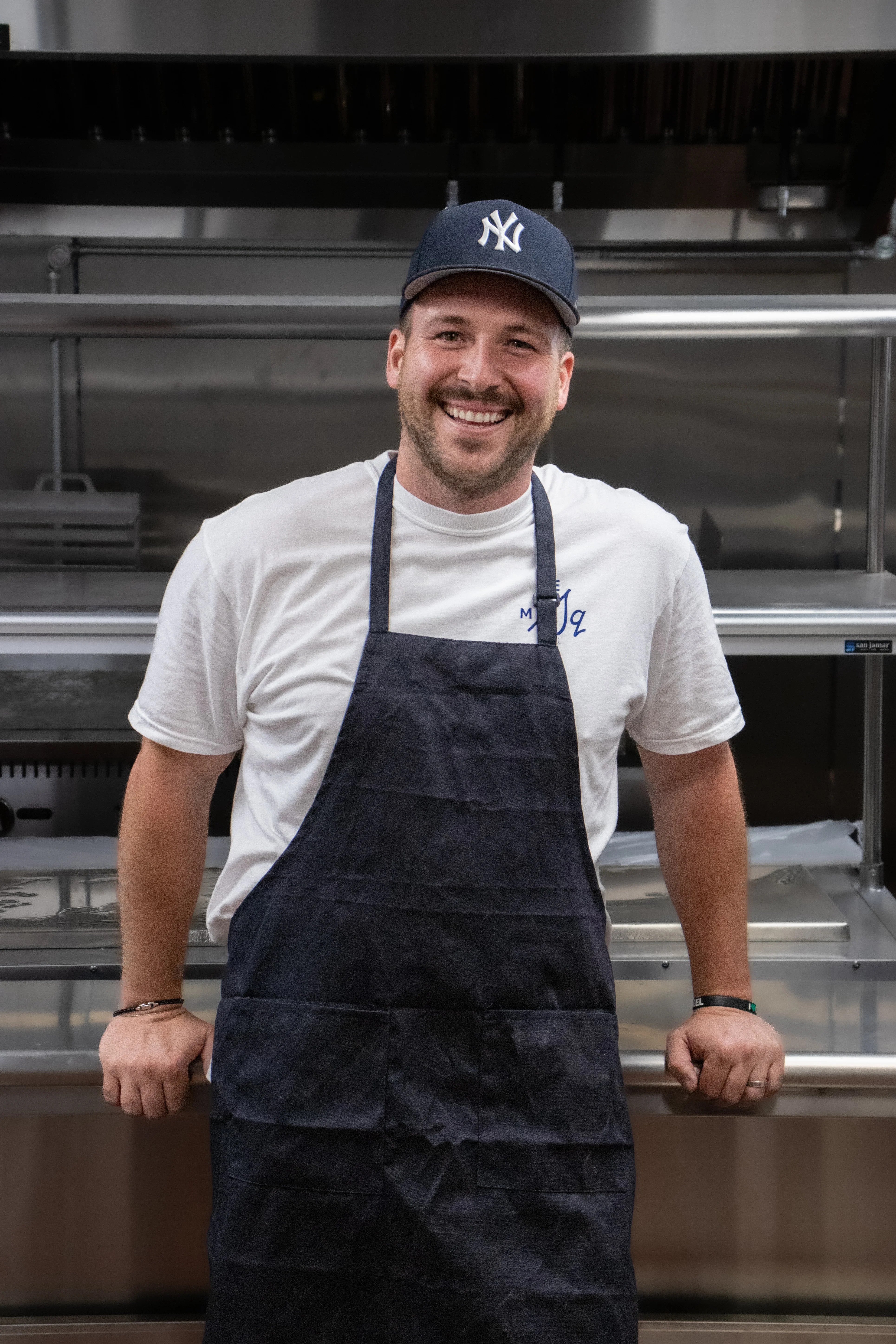 Chef smiling in a modern kitchen setting