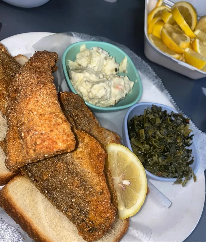 Southern fried catfish with sides of coleslaw and collard greens