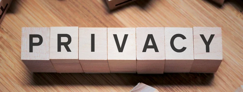 Wooden blocks spelling out 'PRIVACY' on a table