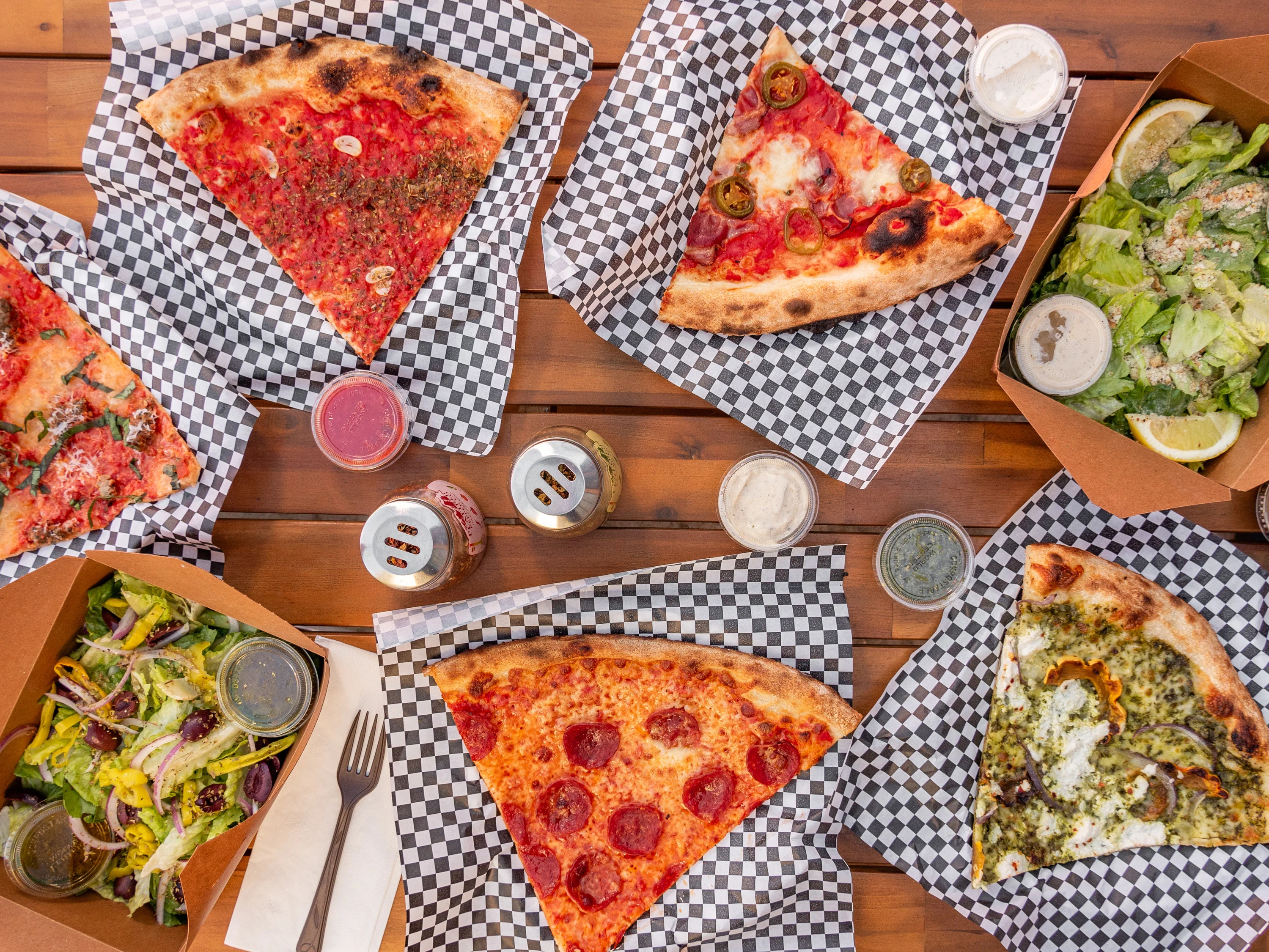 Holiday announcement for Checkerboard Pizza with playful illustration and vibrant design