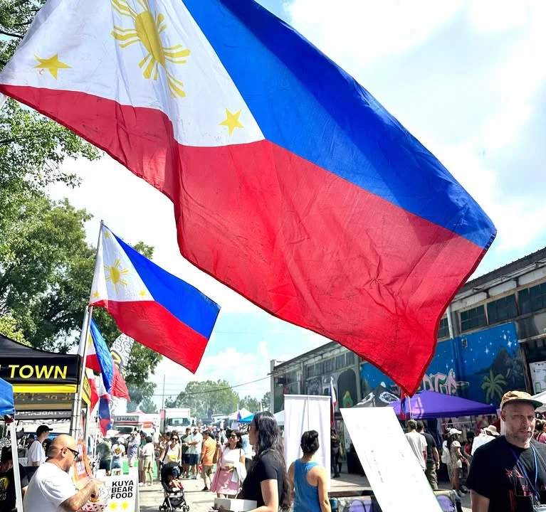 Philippine flags waving at a vibrant cultural festival
