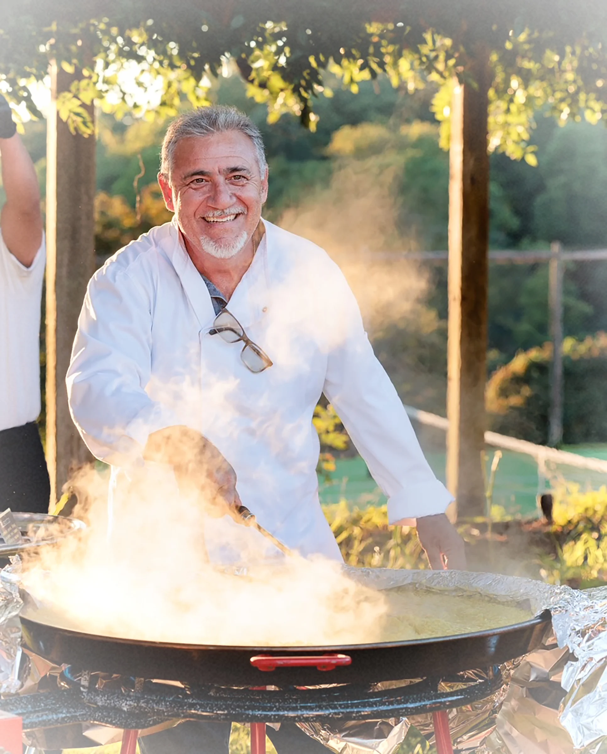 Chef preparing traditional Spanish paella outdoors