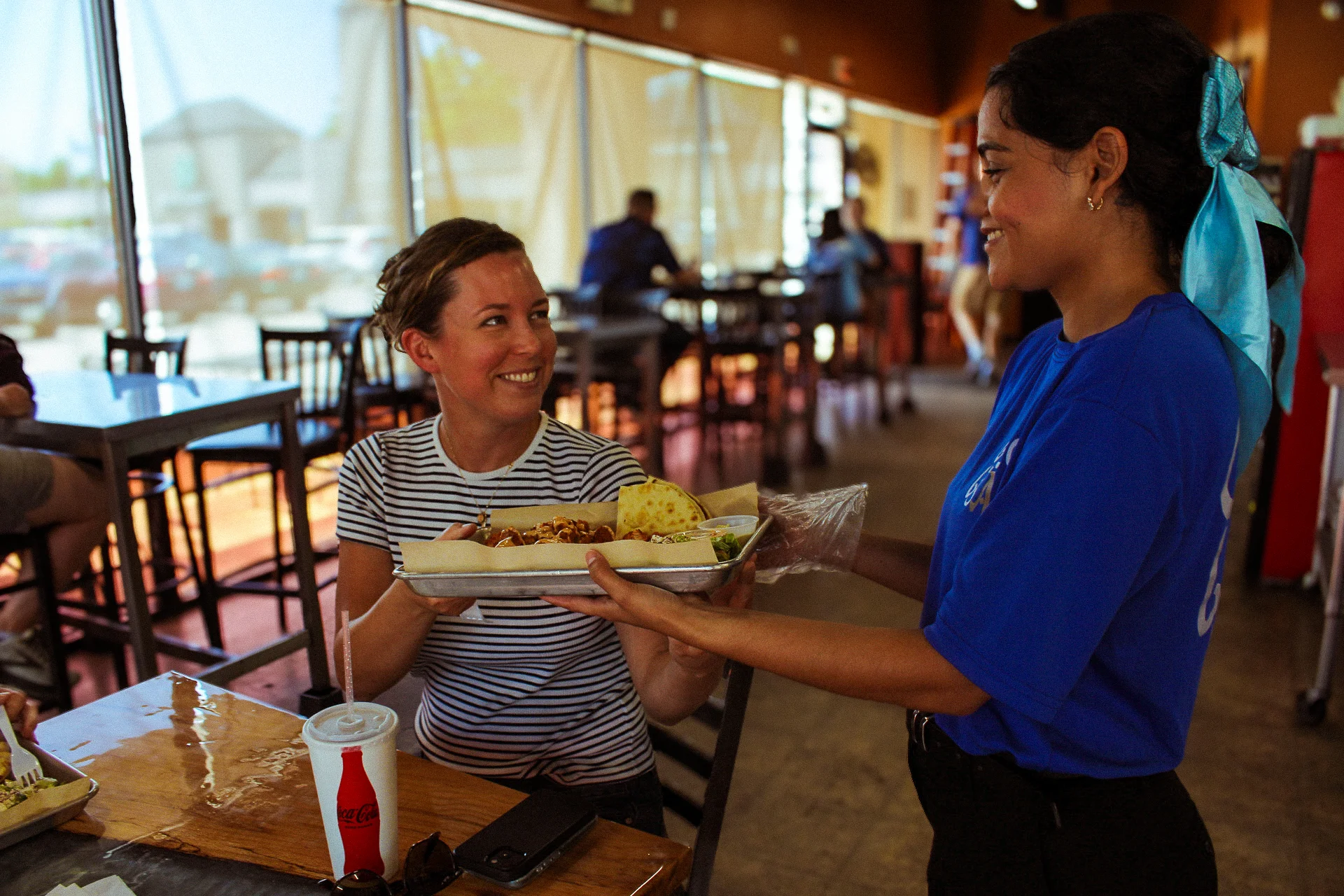 A waitress serving a plate to a customer