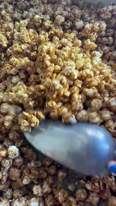 A close-up view of caramel-coated popcorn, indicating a sweet and crunchy snack.