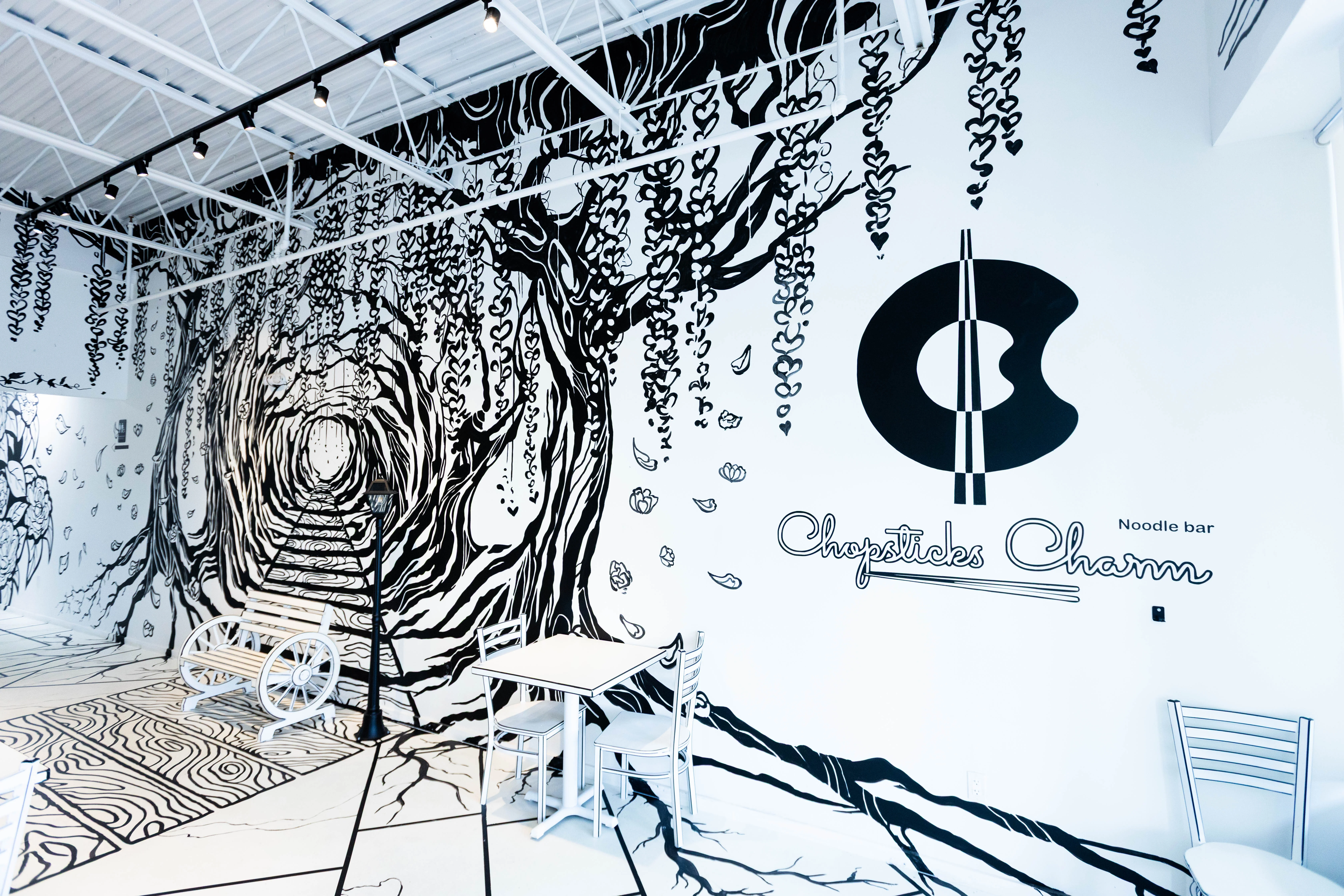  A unique dining table at Chopsticks Charm with a beautiful white, 2-D styled tree growing from its center.