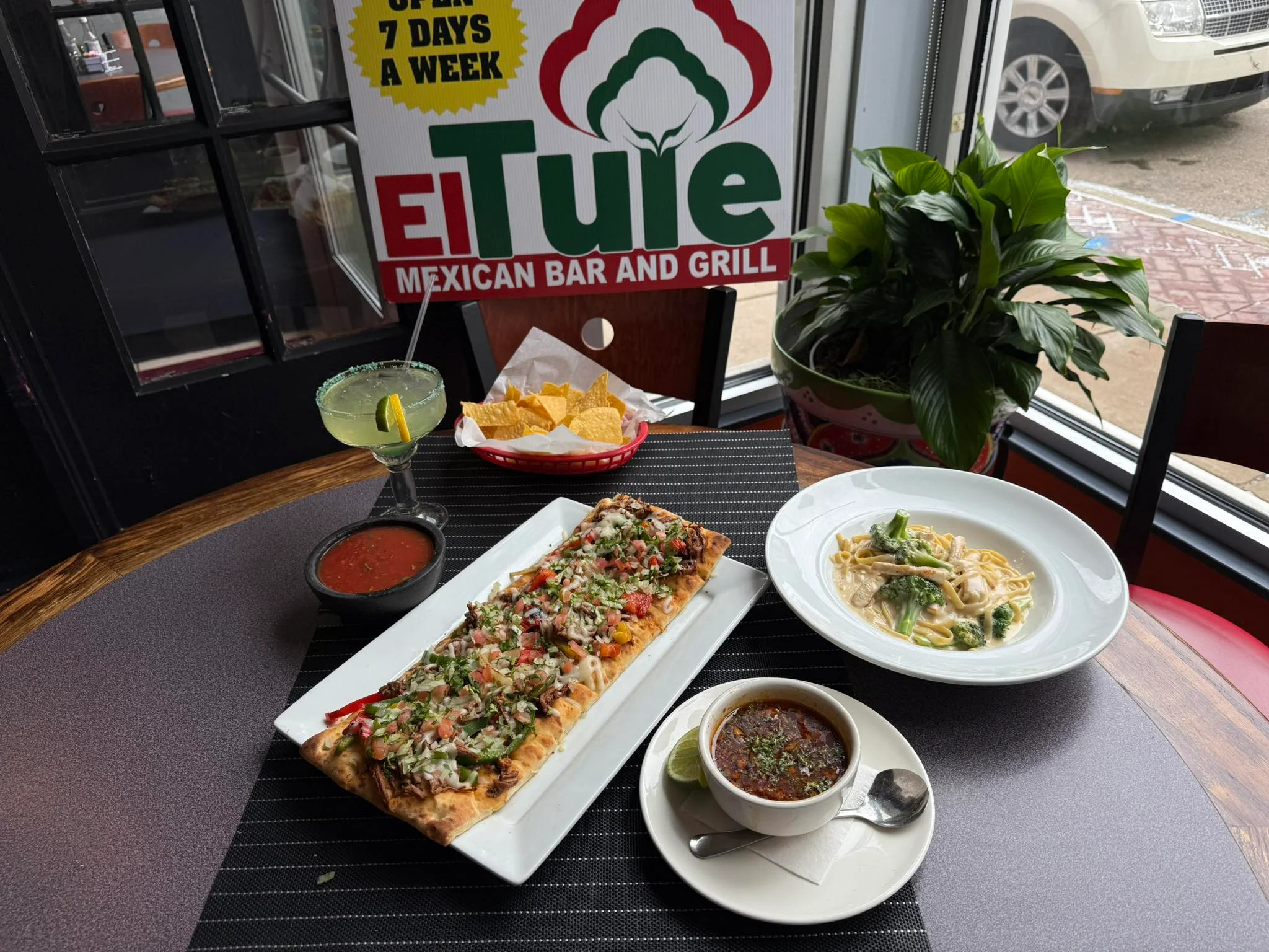 Mexican fajitas served with salsa and margarita in a vibrant restaurant setting