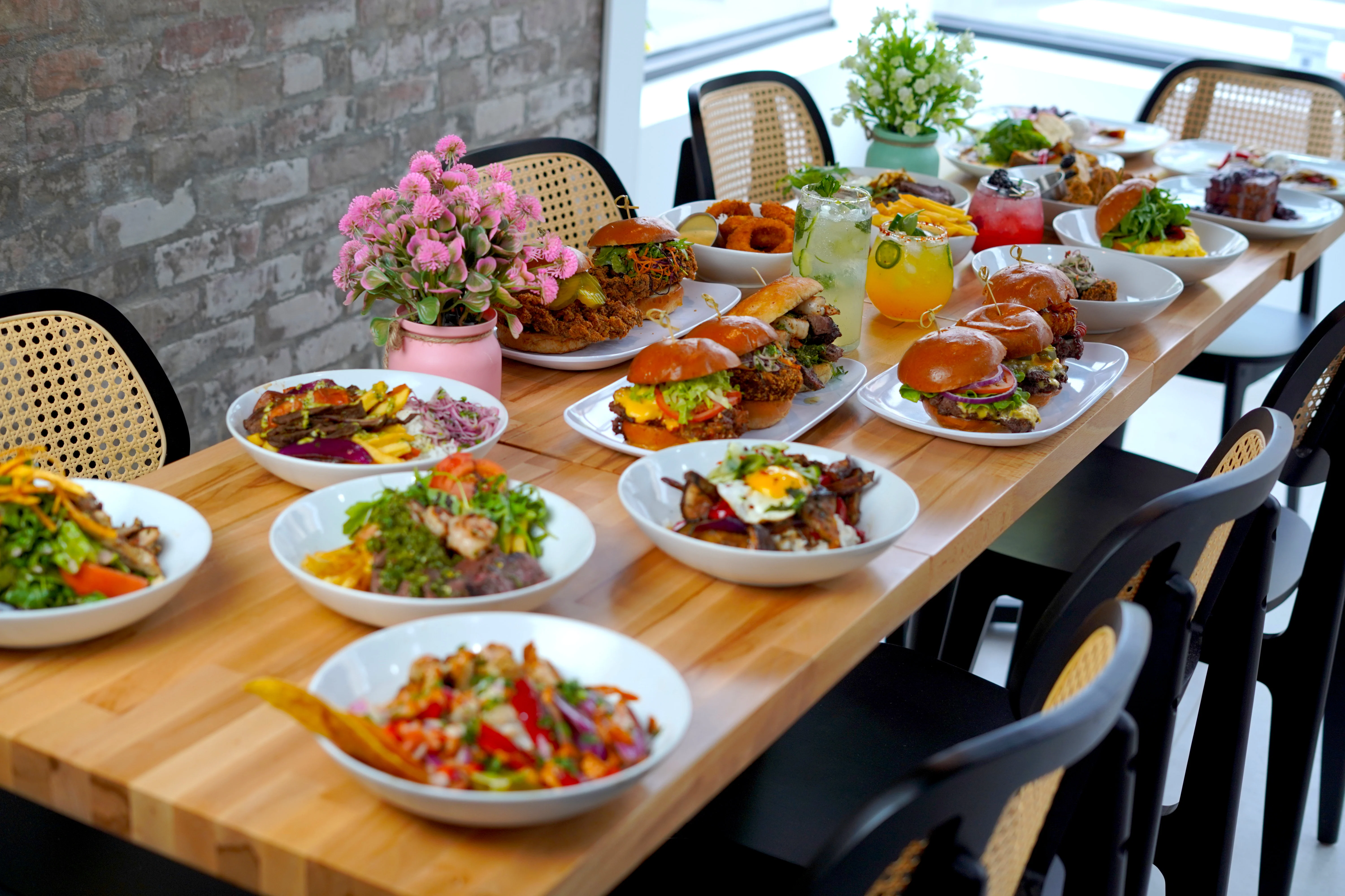 Diverse selection of global dishes on a wooden dining table
