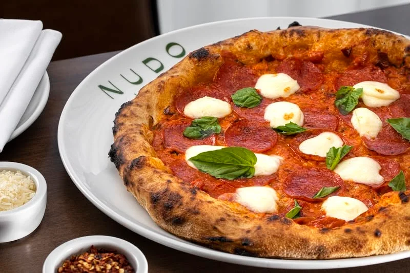 Pepperoni pizza with fresh mozzarella and basil