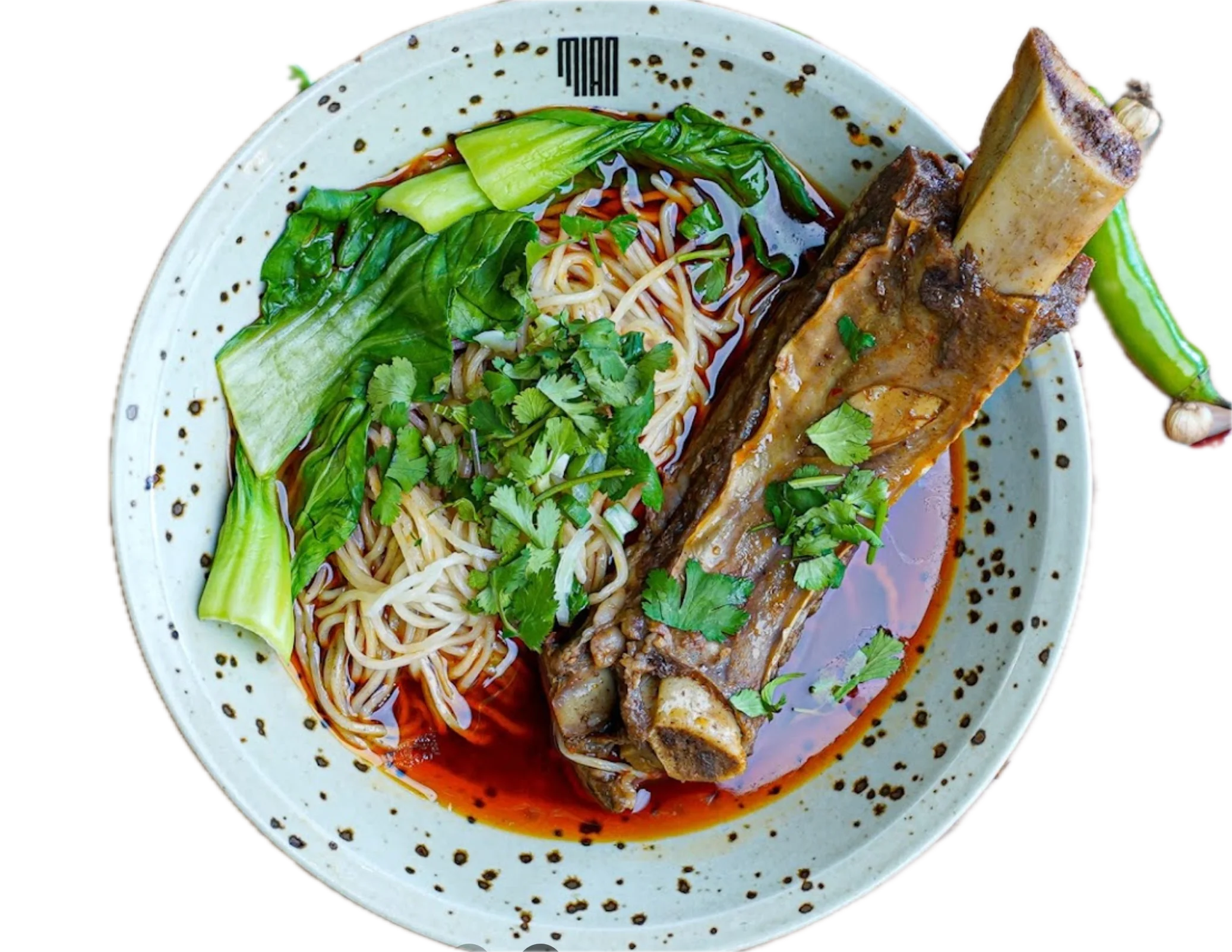Delicious spicy beef rib served on a plate with garnishes.