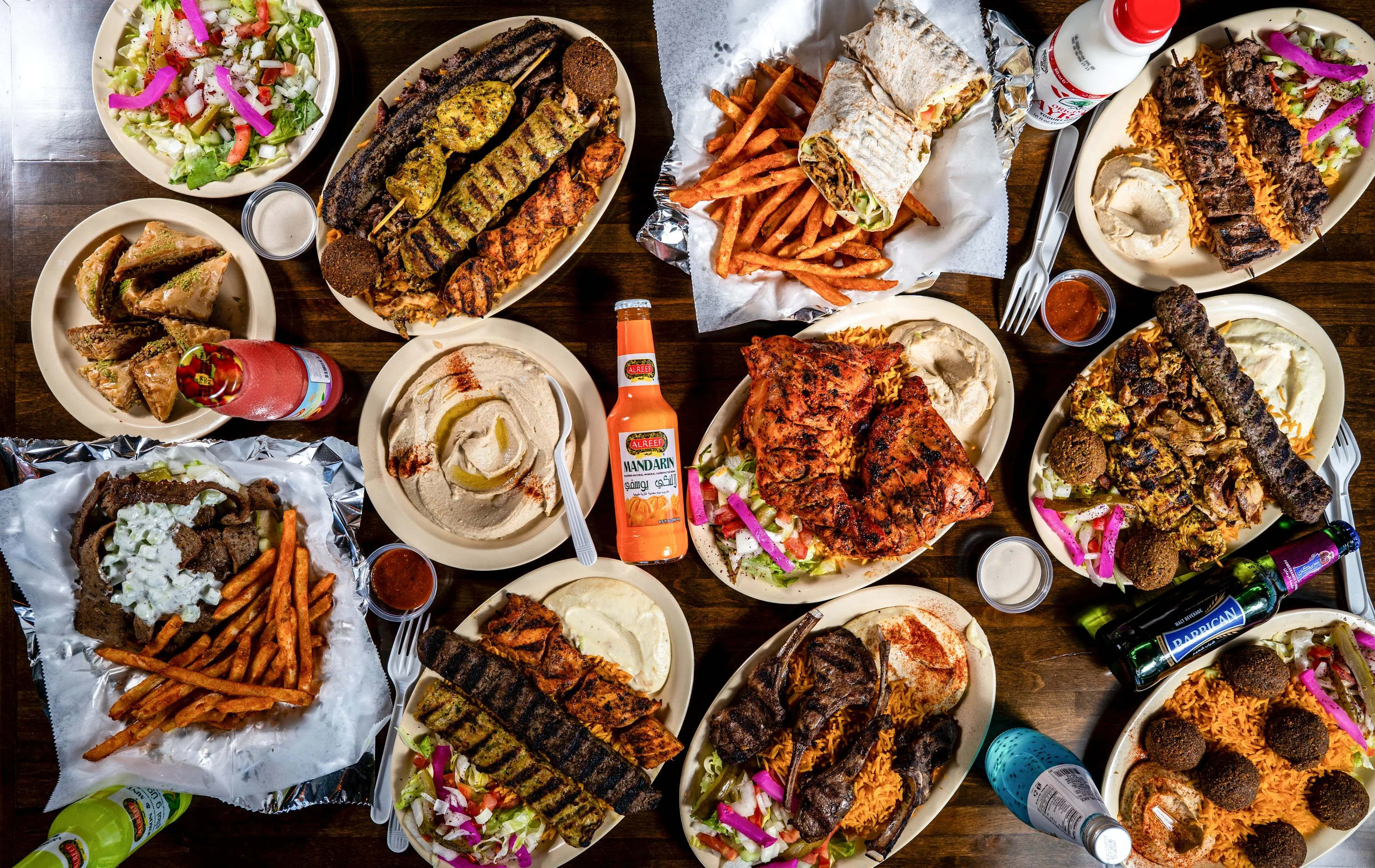 Middle Eastern mixed grill platter with rice and sauces