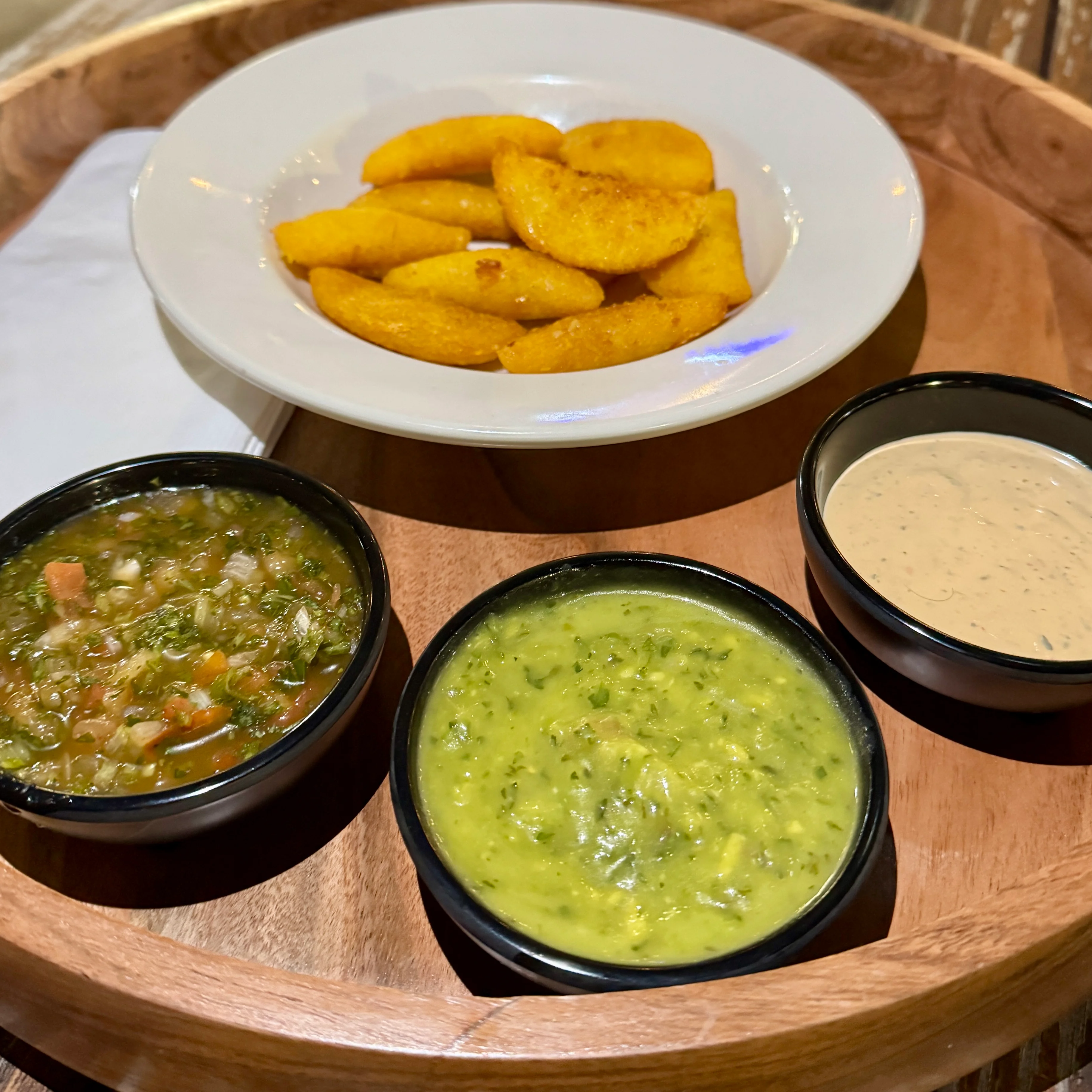Colombian arepas with three vibrant sauces