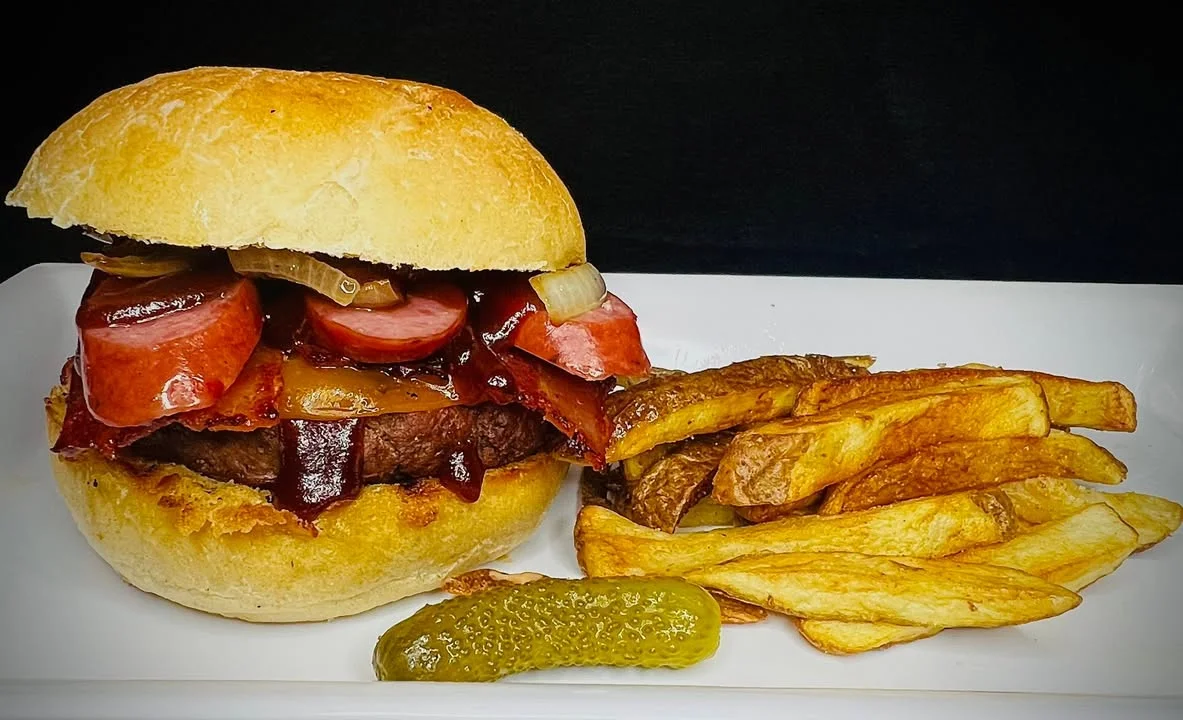 Delicious gourmet burger with fresh toppings on a wooden table
