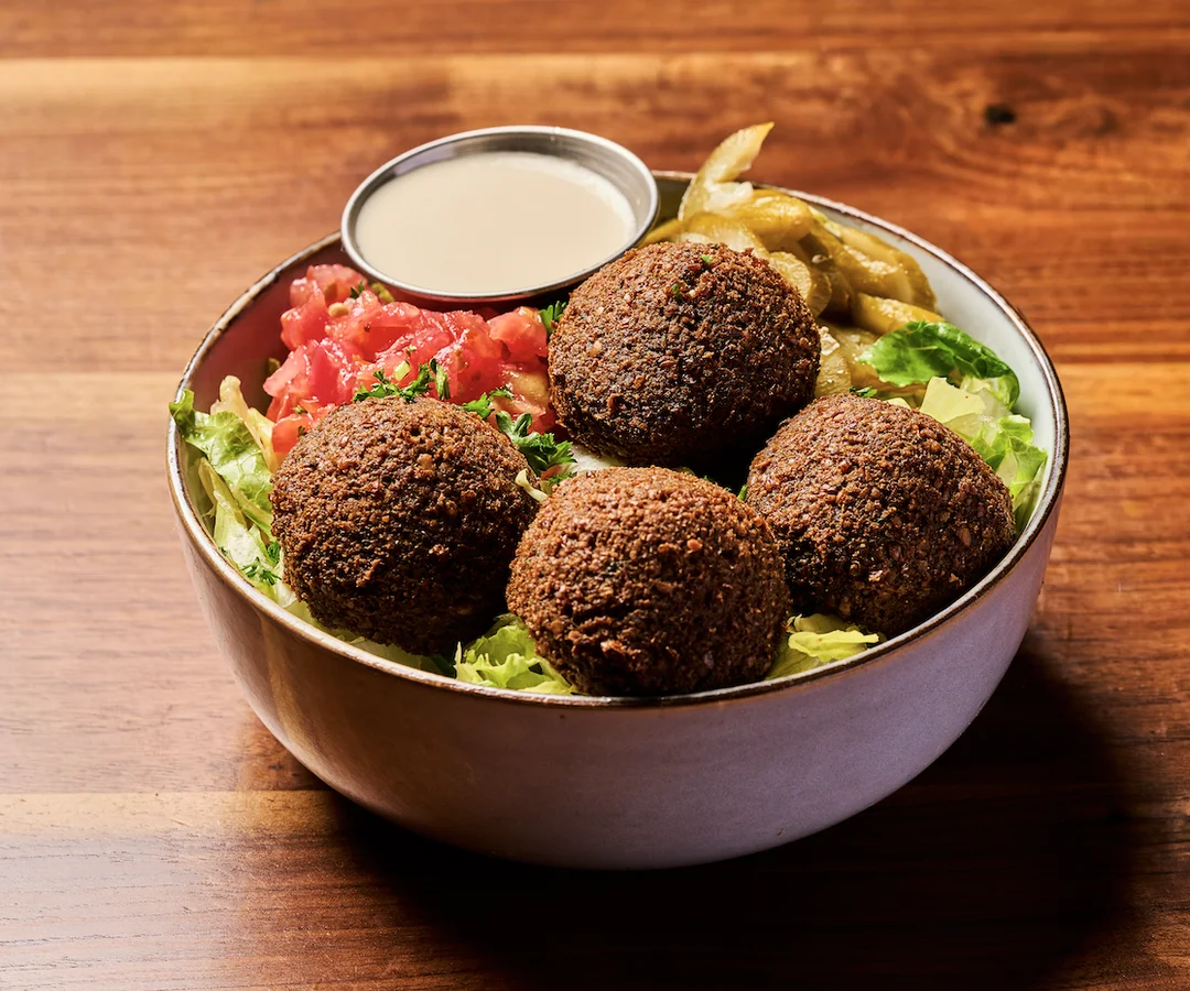Delicious shawarma platter with fresh vegetables and sauces