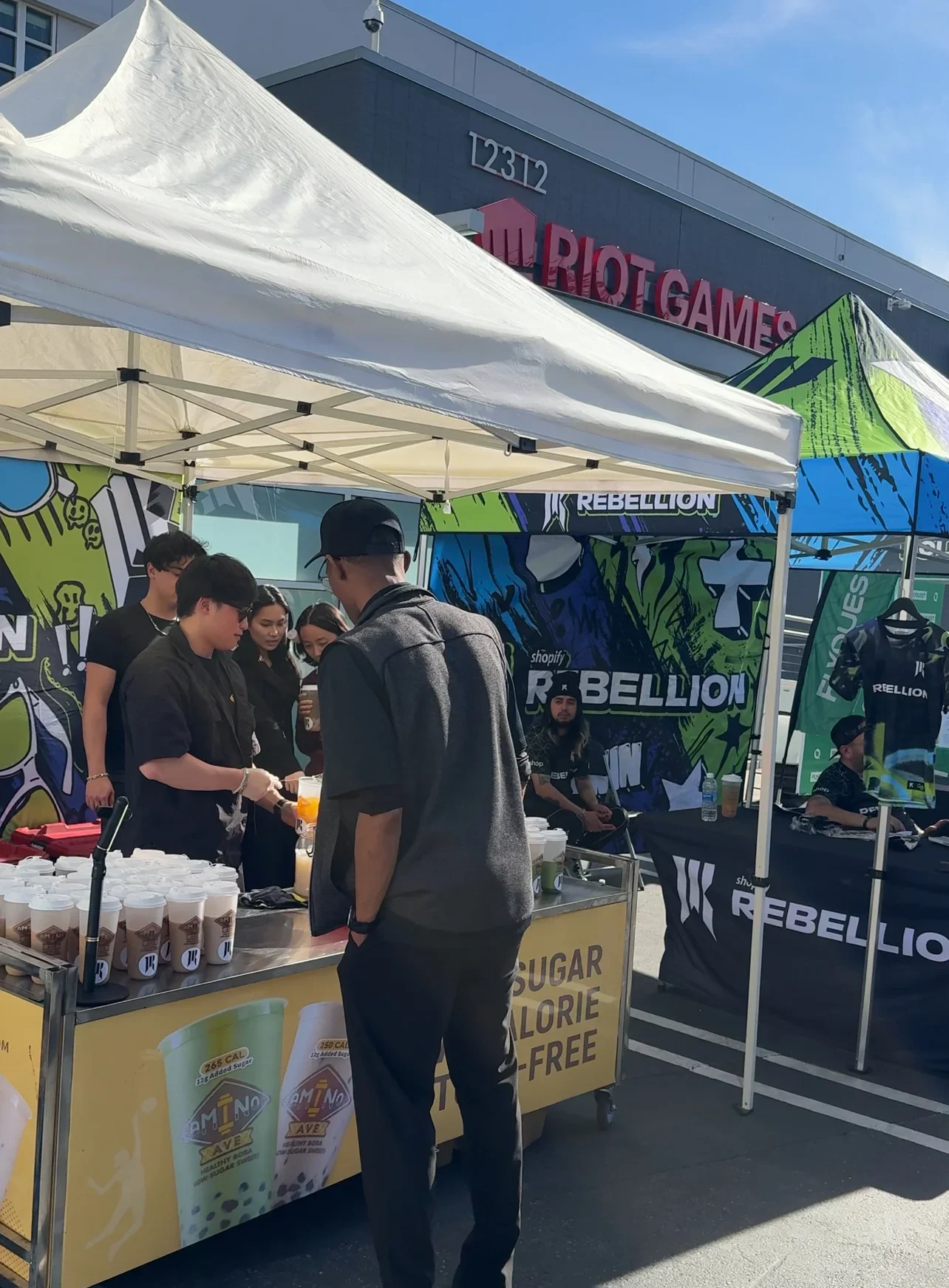 Outdoor event booth with drinks and promotional materials