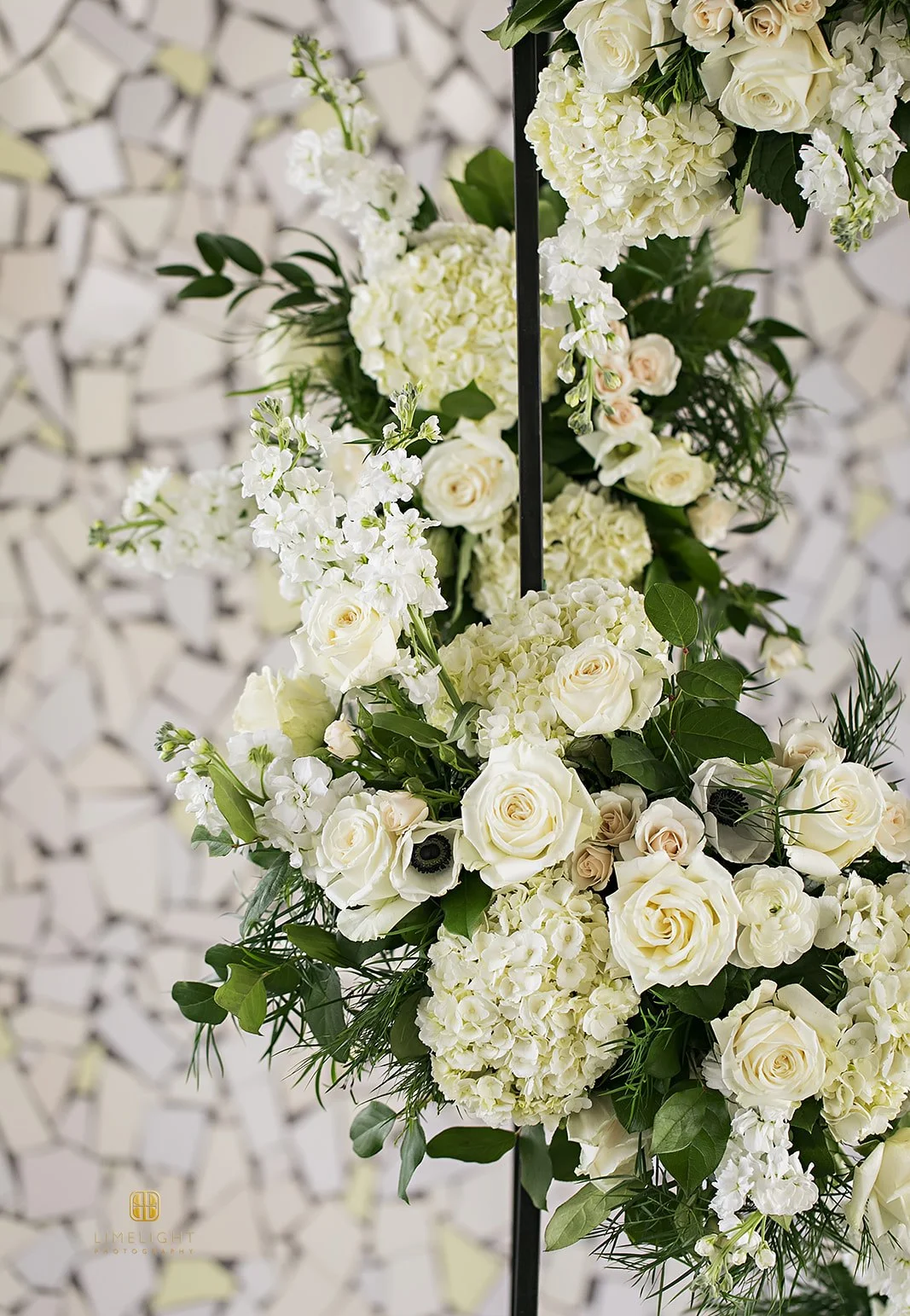 Elegant floral arrangement with white roses and greenery