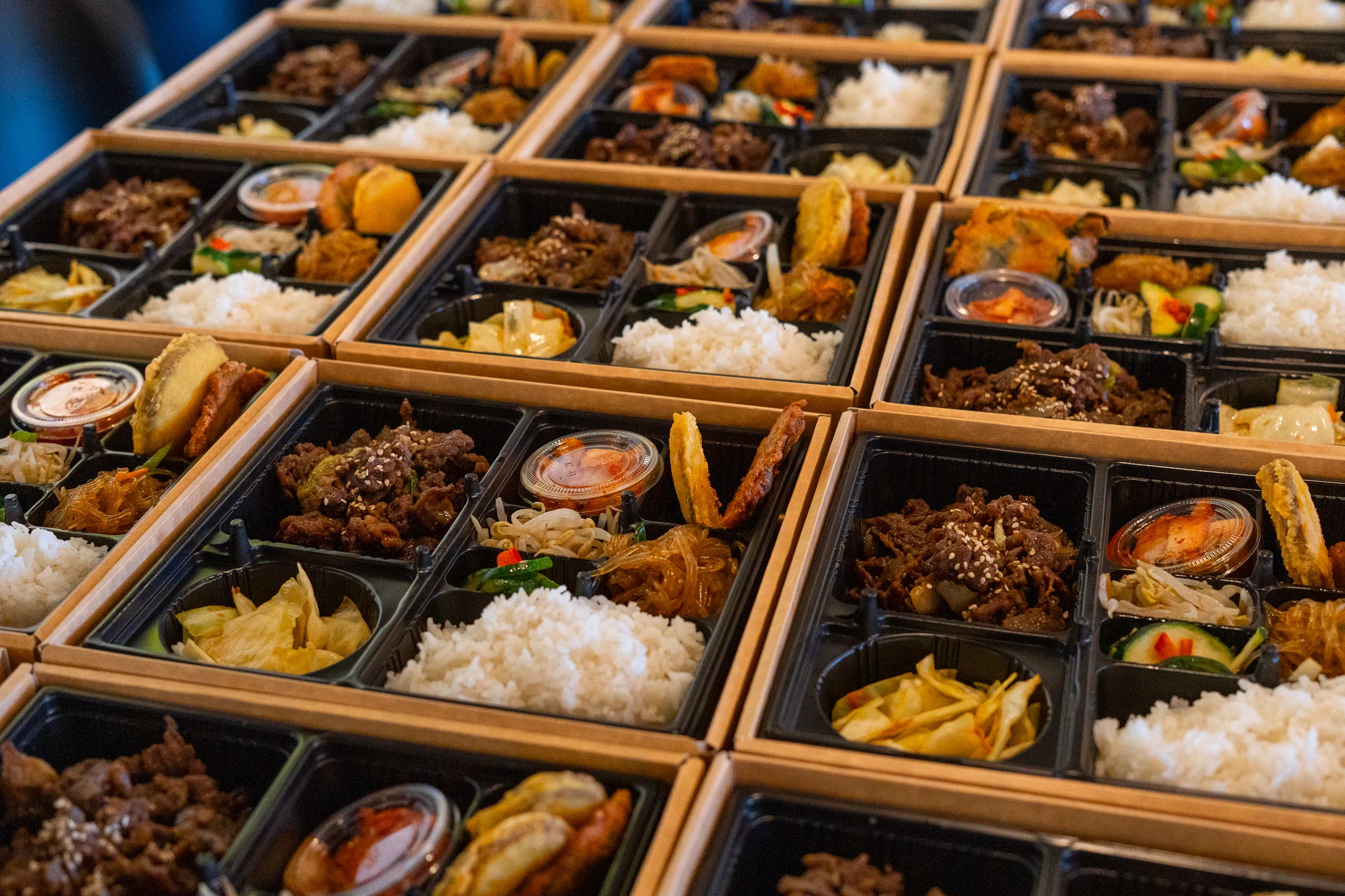 Assorted Korean bento boxes with rice and side dishes