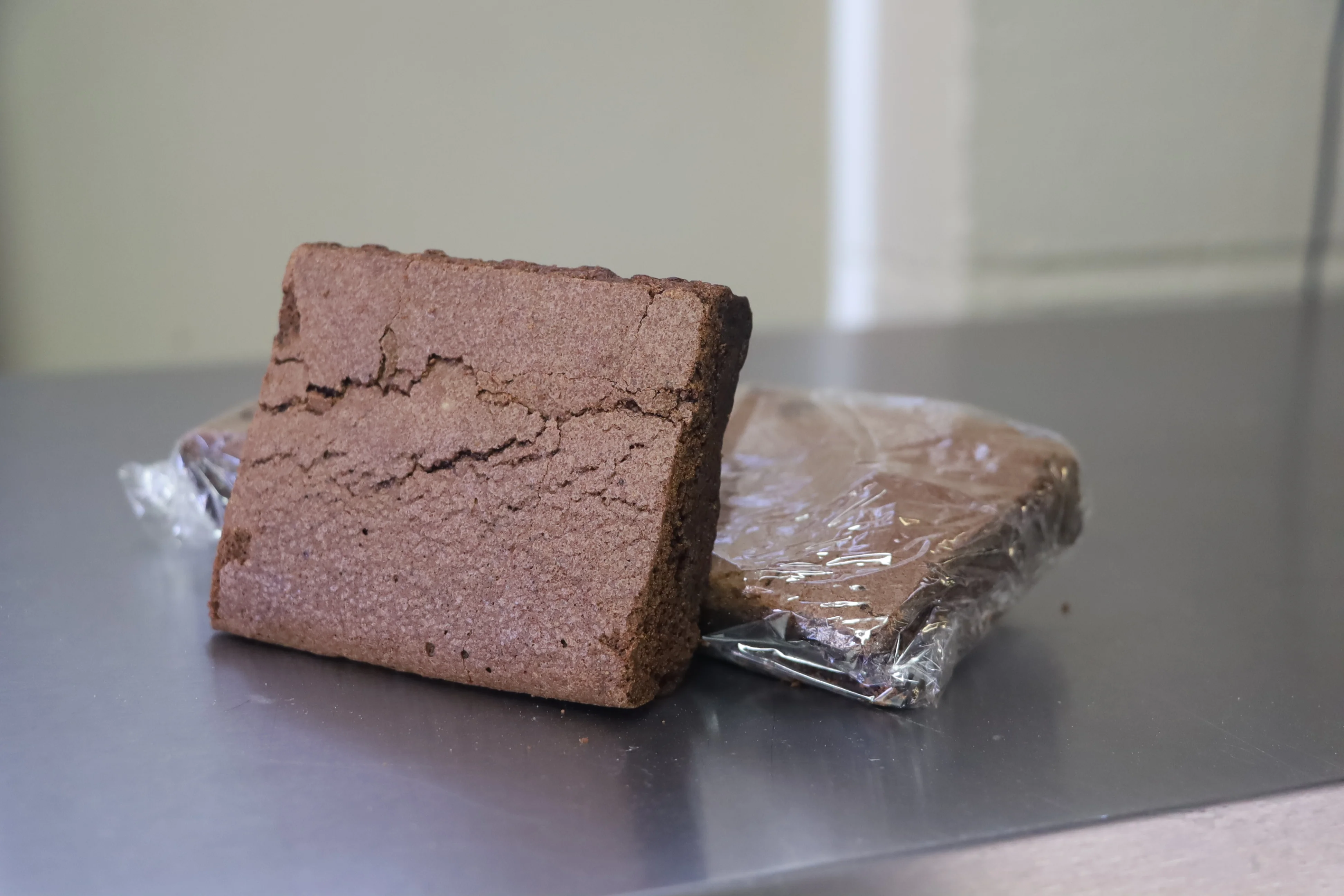 Rich chocolate brownie on a stainless steel surface