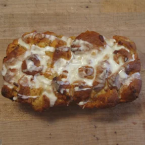Cinnamon roll bread pudding drizzled with icing