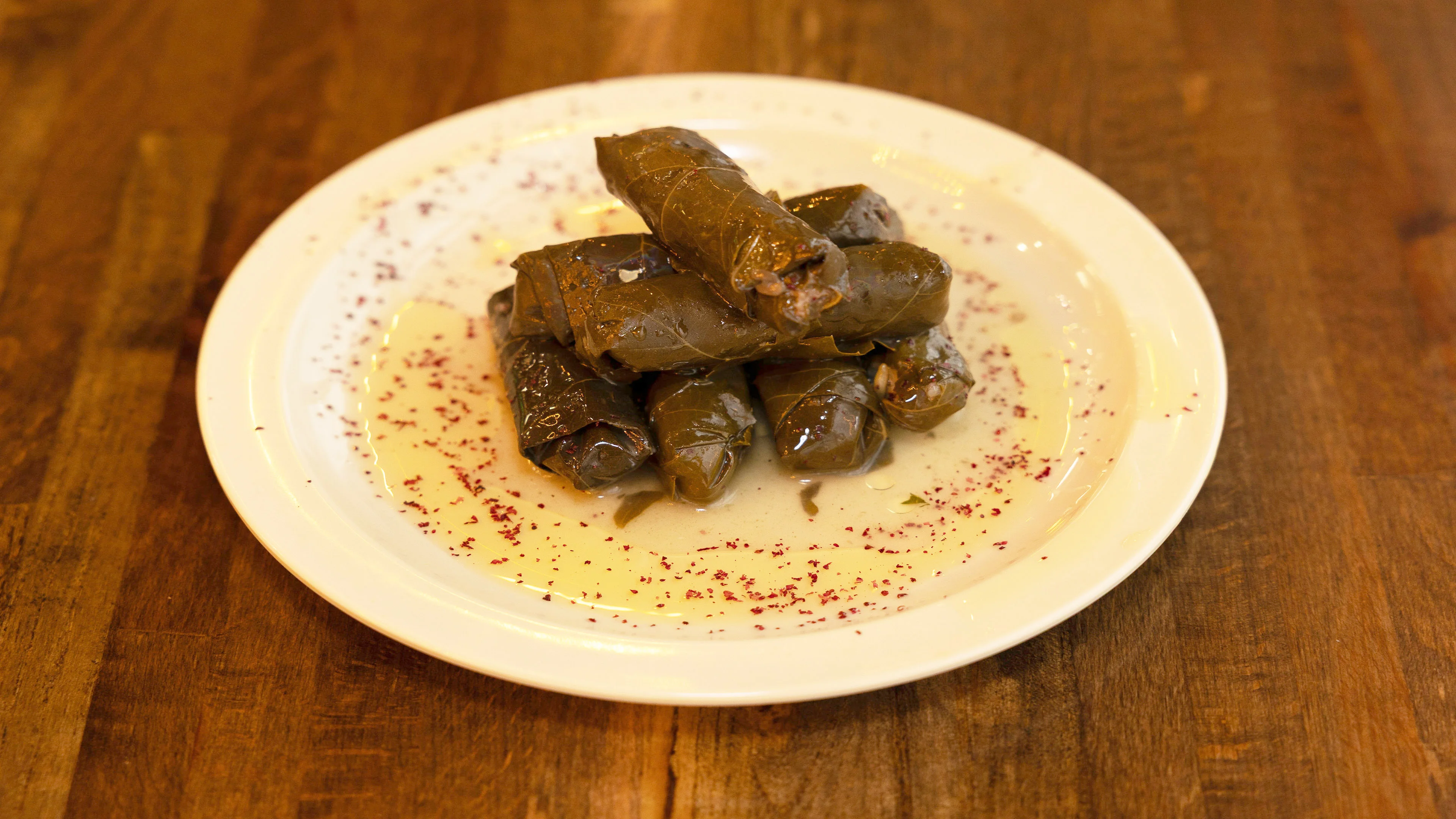 Pita Zone stuffed grape leaves served over hummus
