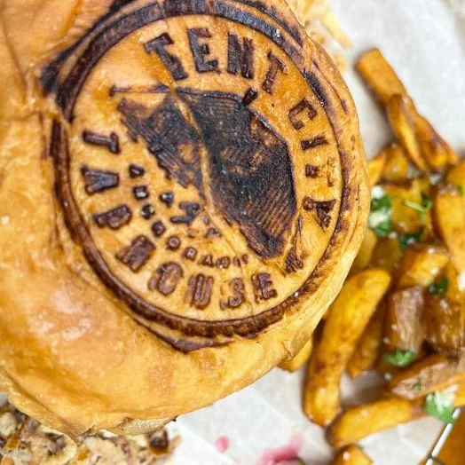 Grilled burger with branded bun and crispy fries