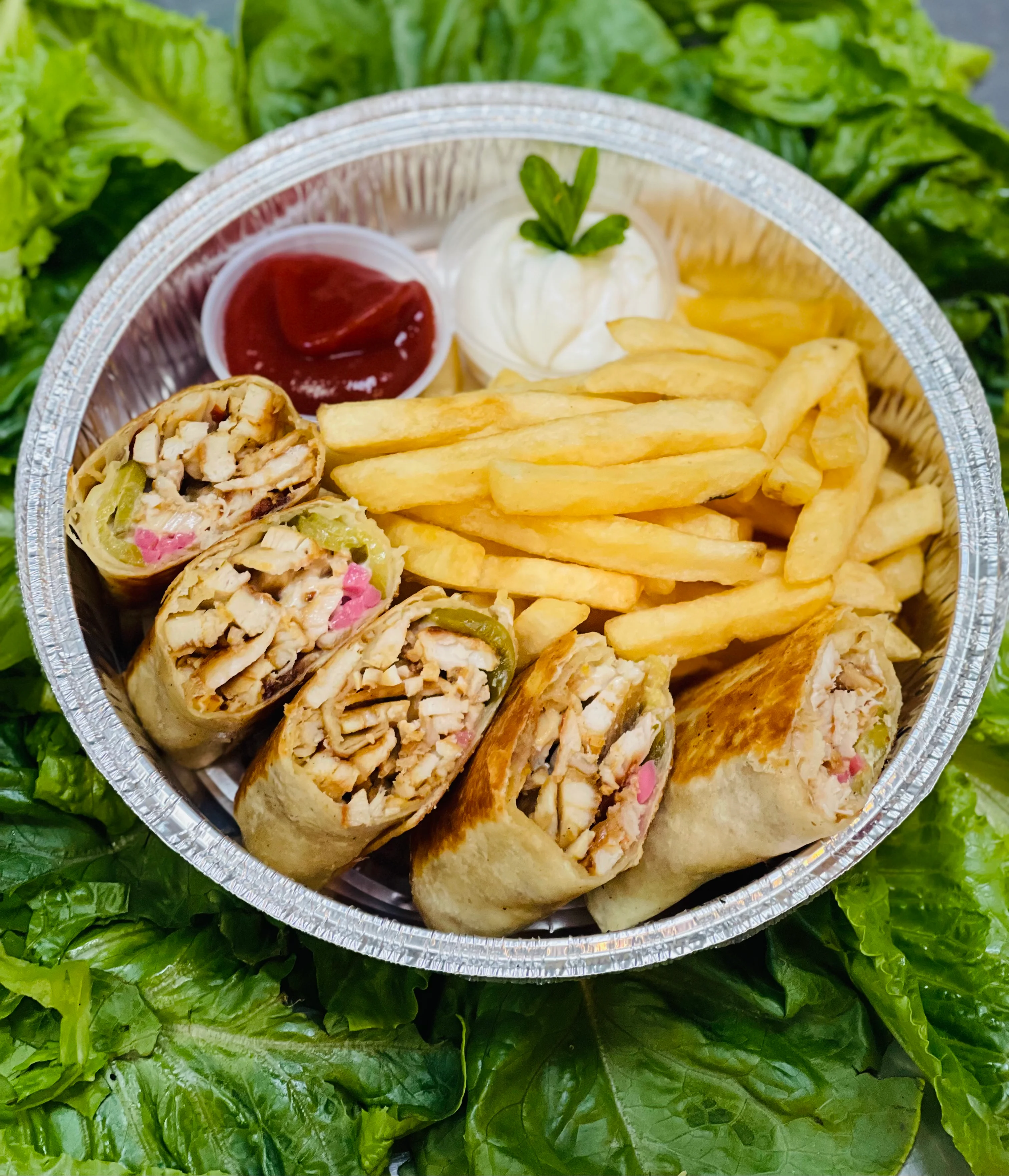 Grilled chicken wraps with fries and dipping sauces