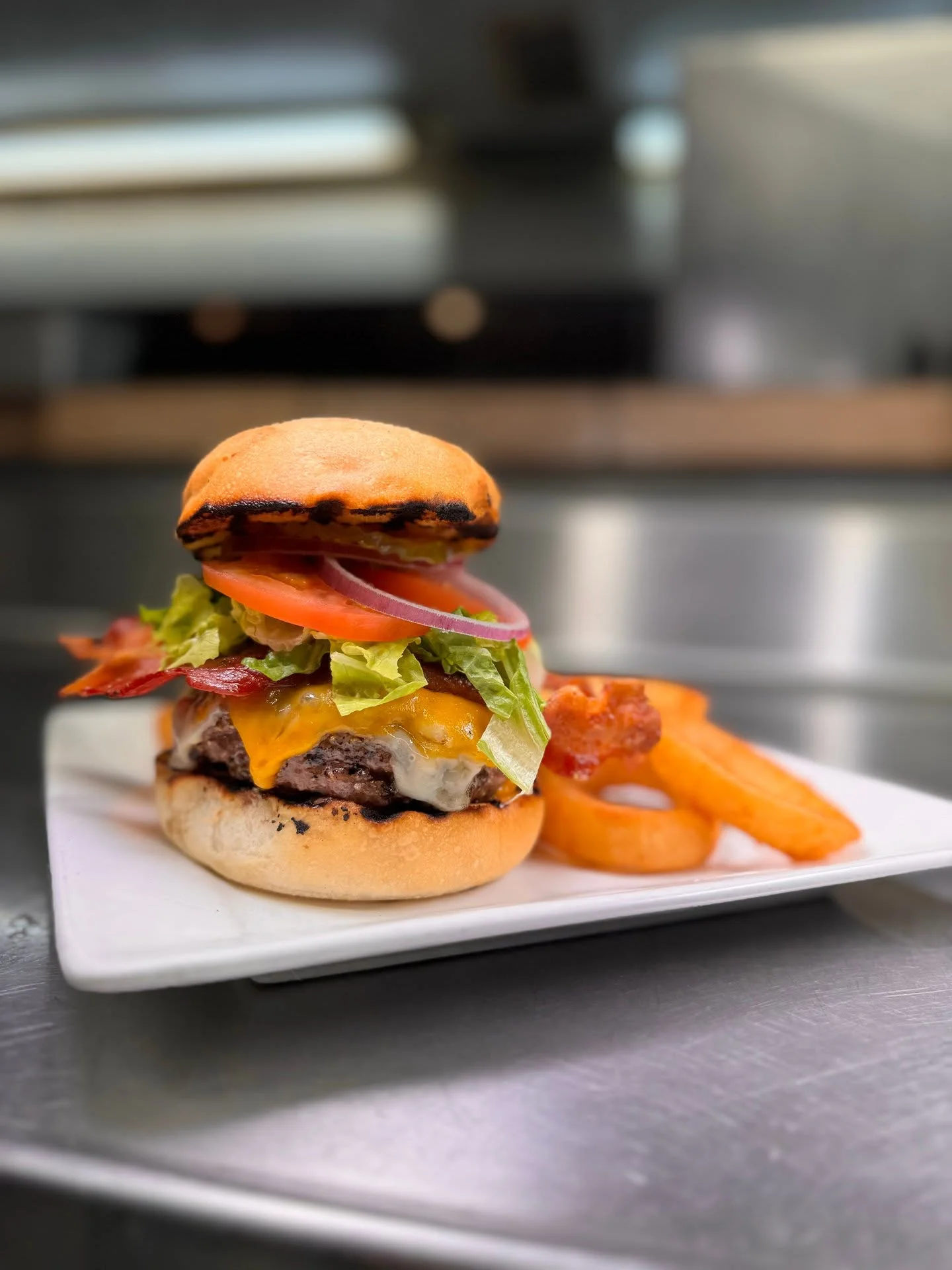 Juicy American cheeseburger with bacon and fresh toppings