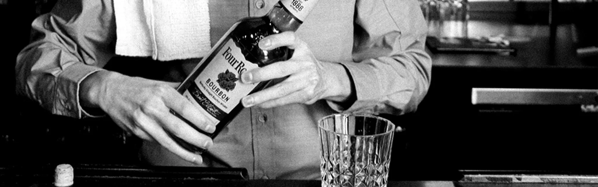 Bartender pouring bourbon into a glass