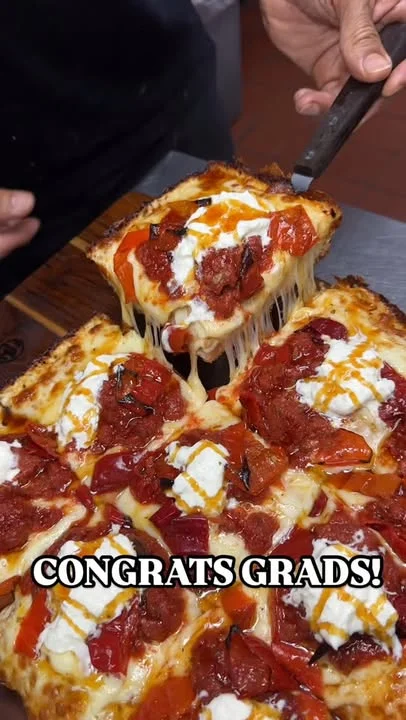 Cheesy pizza with roasted peppers celebrating graduation