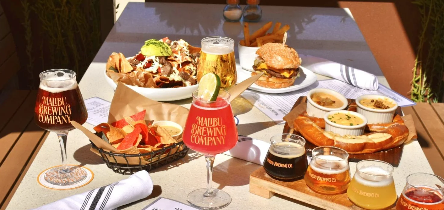 craft beers, smash burger and nachos on a table