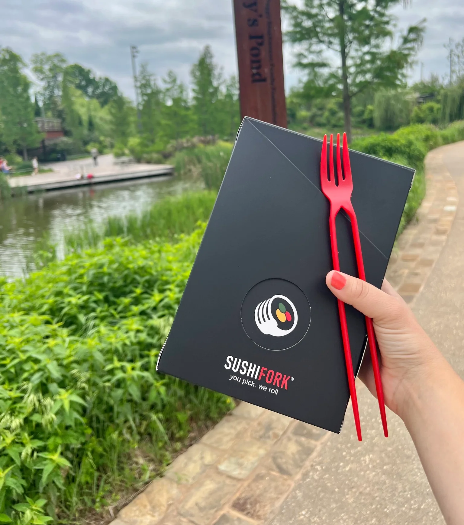 Takeout sushi box from SushiFork by a pond