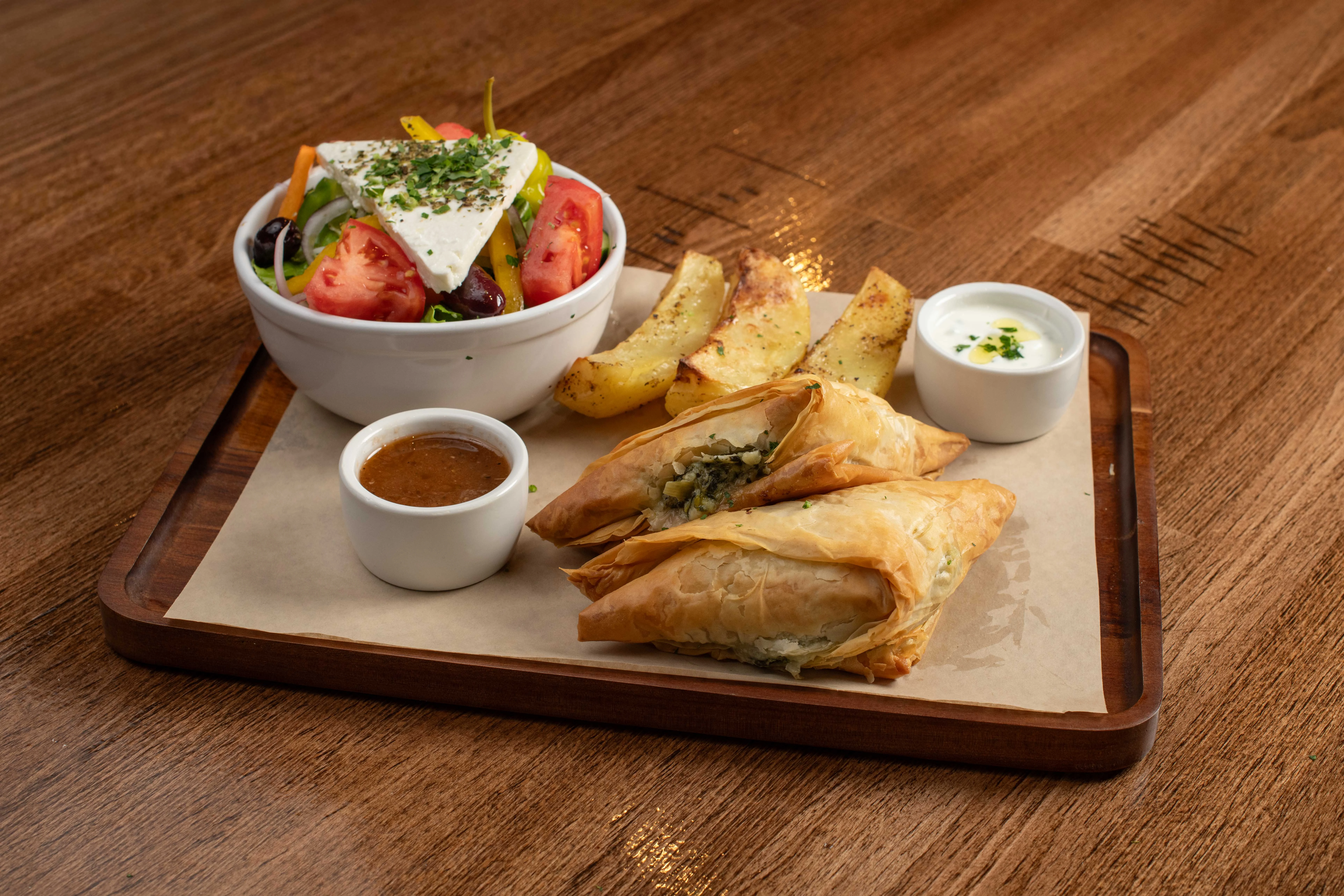 Mediterranean spinach pie with salad and roasted potatoes