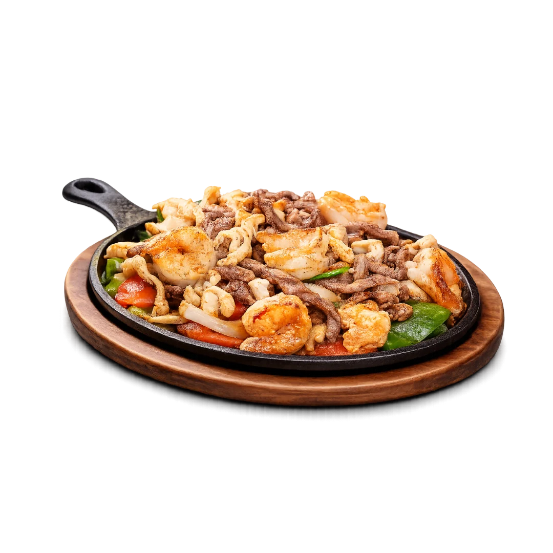 Sizzling fajitas with shrimp and beef on a hot skillet