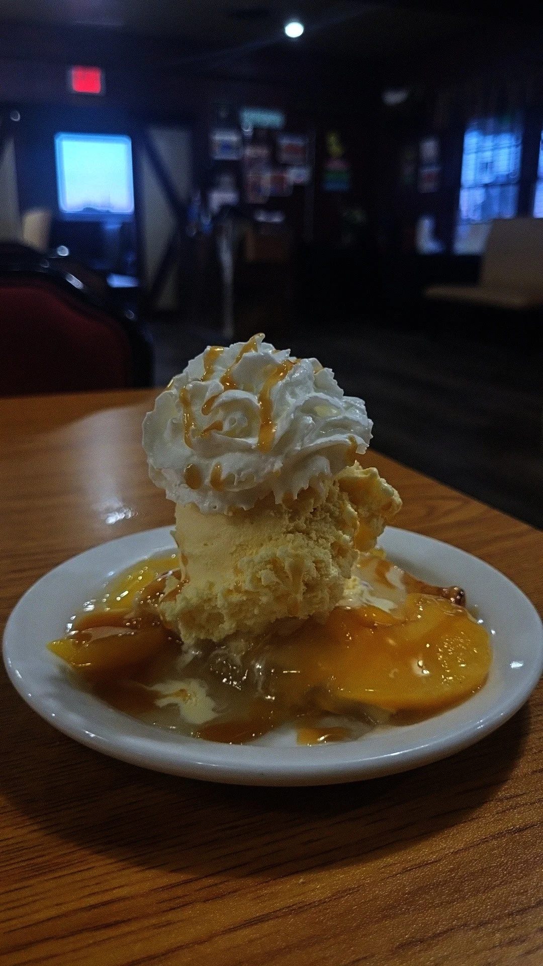 Delicious peach cobbler topped with vanilla ice cream and whipped cream