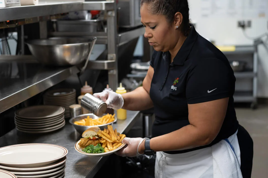 Cook preparing a Cajun fried fish po boy