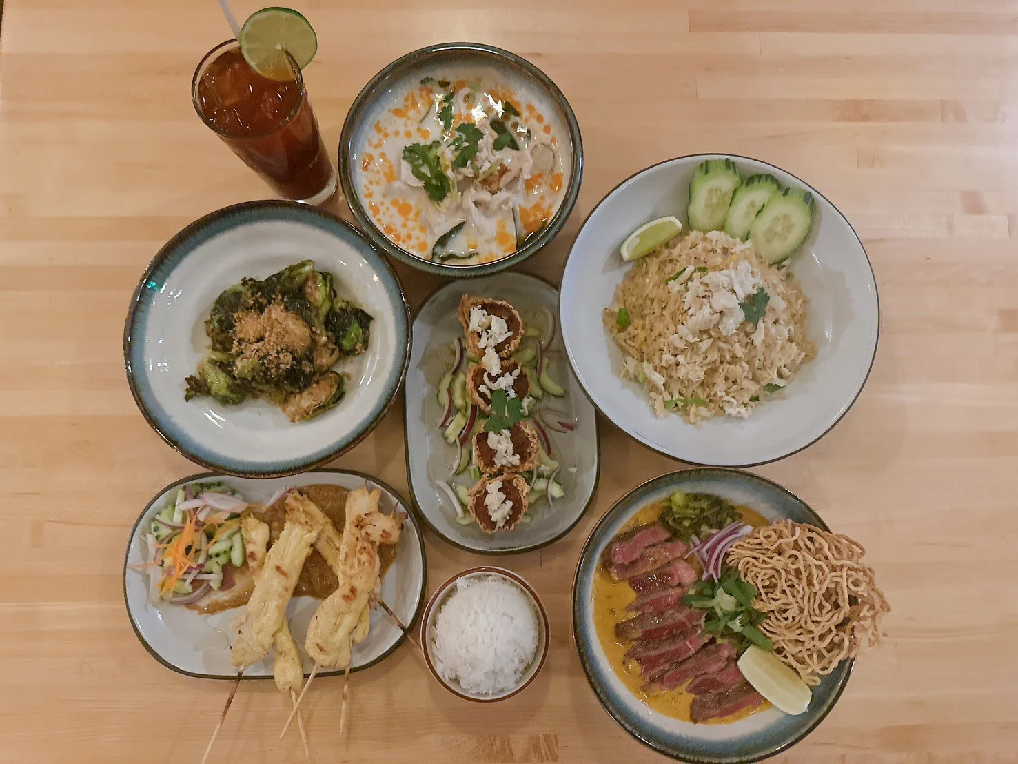 Assorted Thai dishes including satay, fried rice, and curry beef