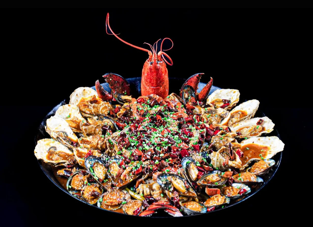 A vibrant seafood platter featuring lobster, oysters, and various shellfish.