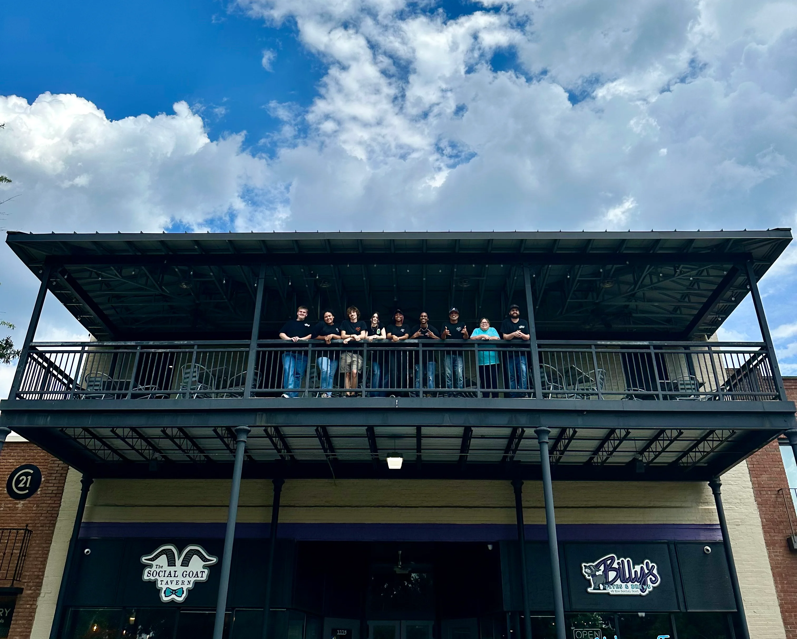Staff posing on balcony of The Social Goat Tavern