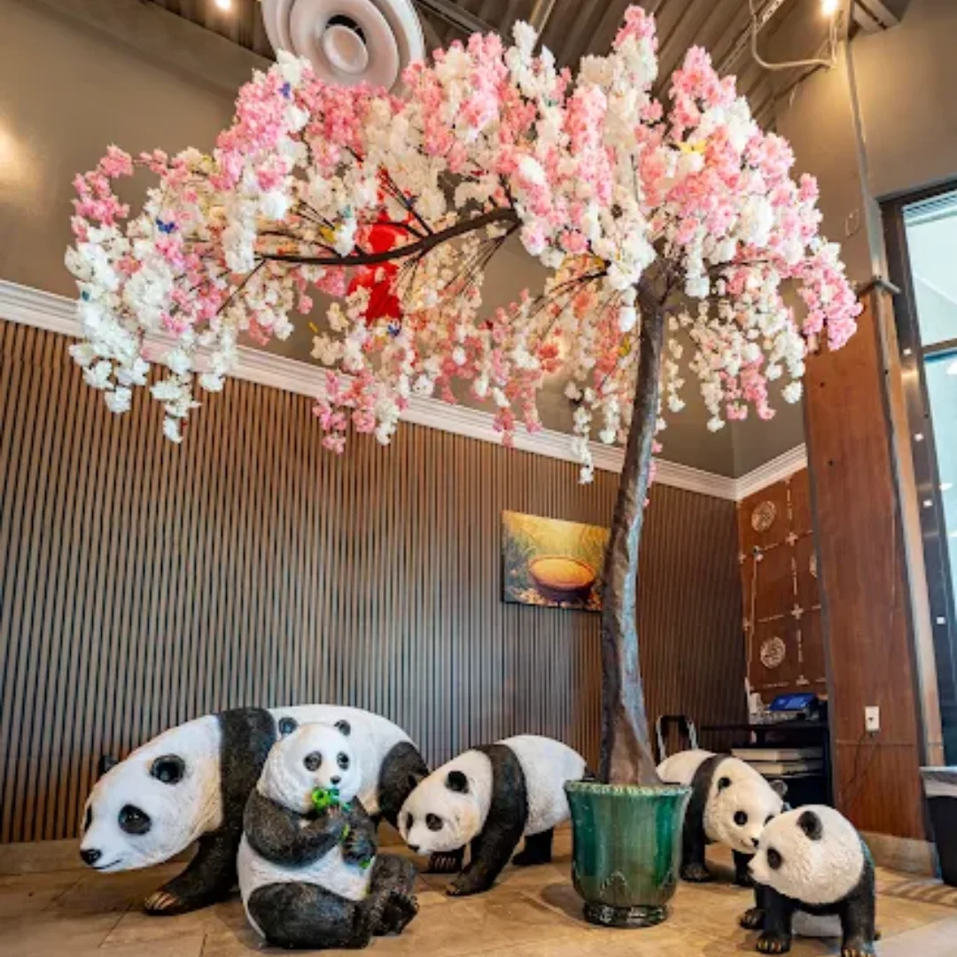 A family enjoying a meal at Shanghai Garden, featuring Panda-themed decor.