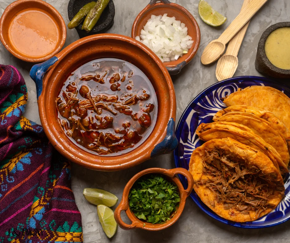 Traditional Mexican birria served with tacos and fresh toppings