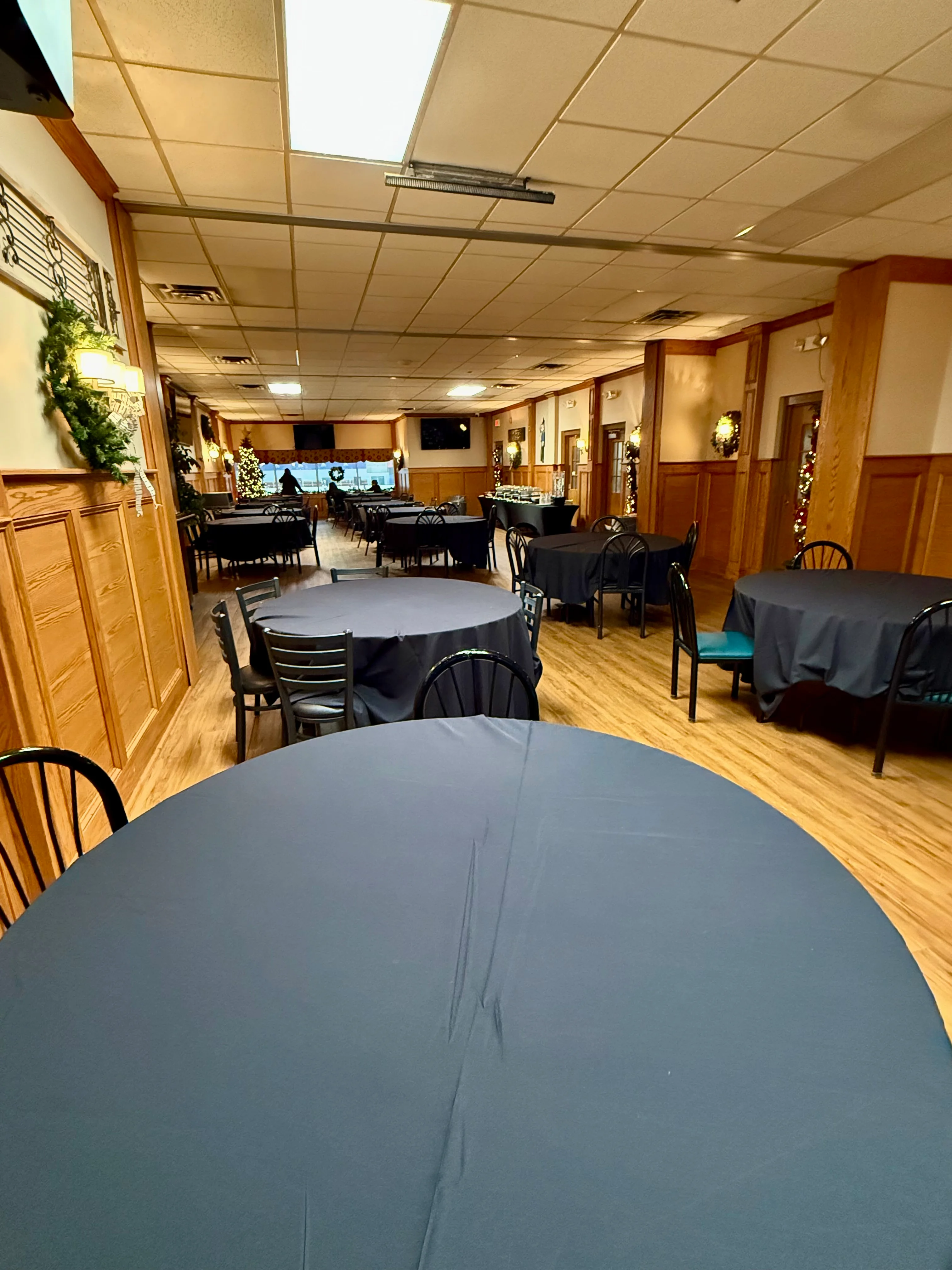 Cozy restaurant interior with round tables and festive decor