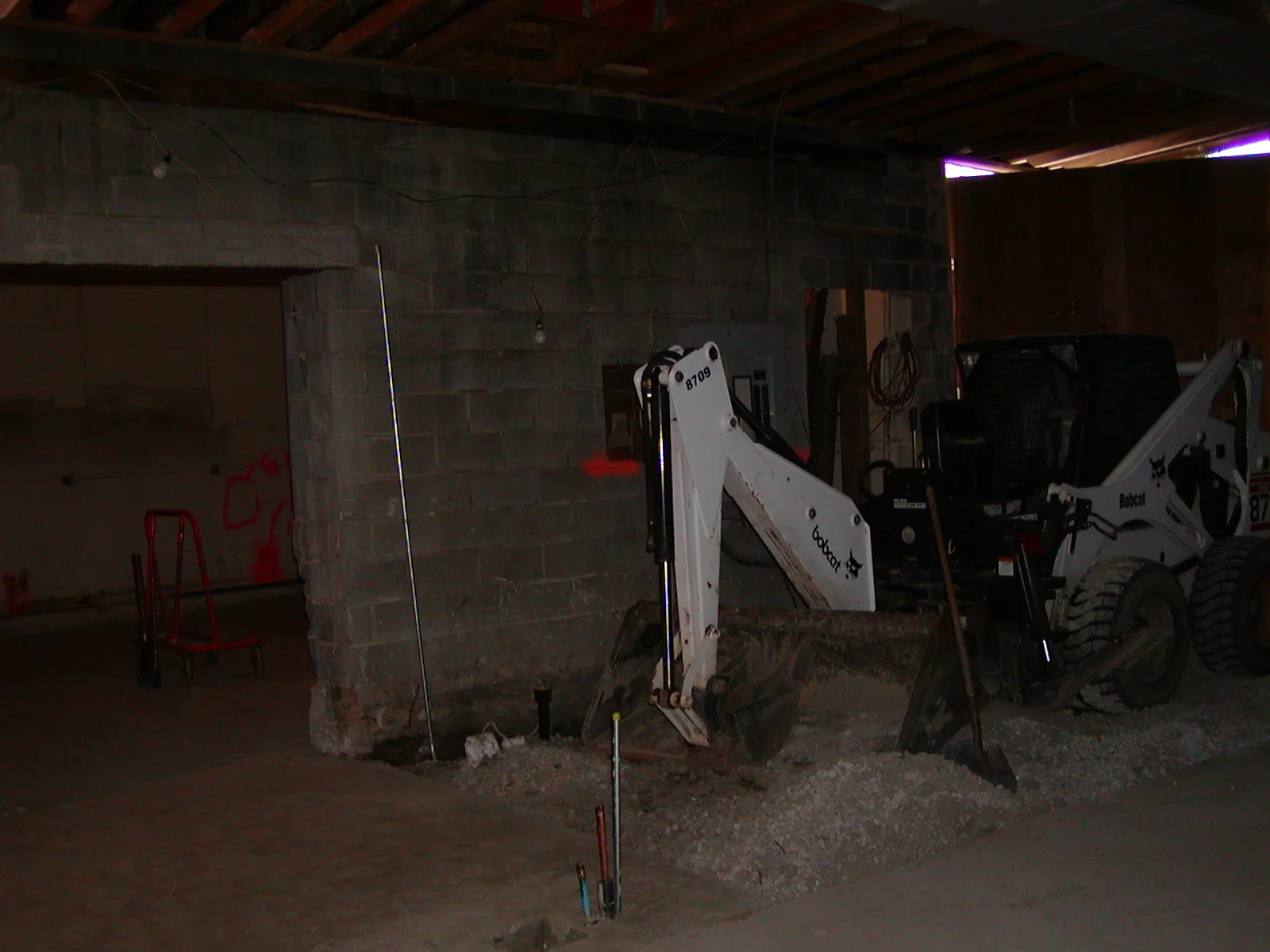 Construction site with heavy machinery and exposed walls