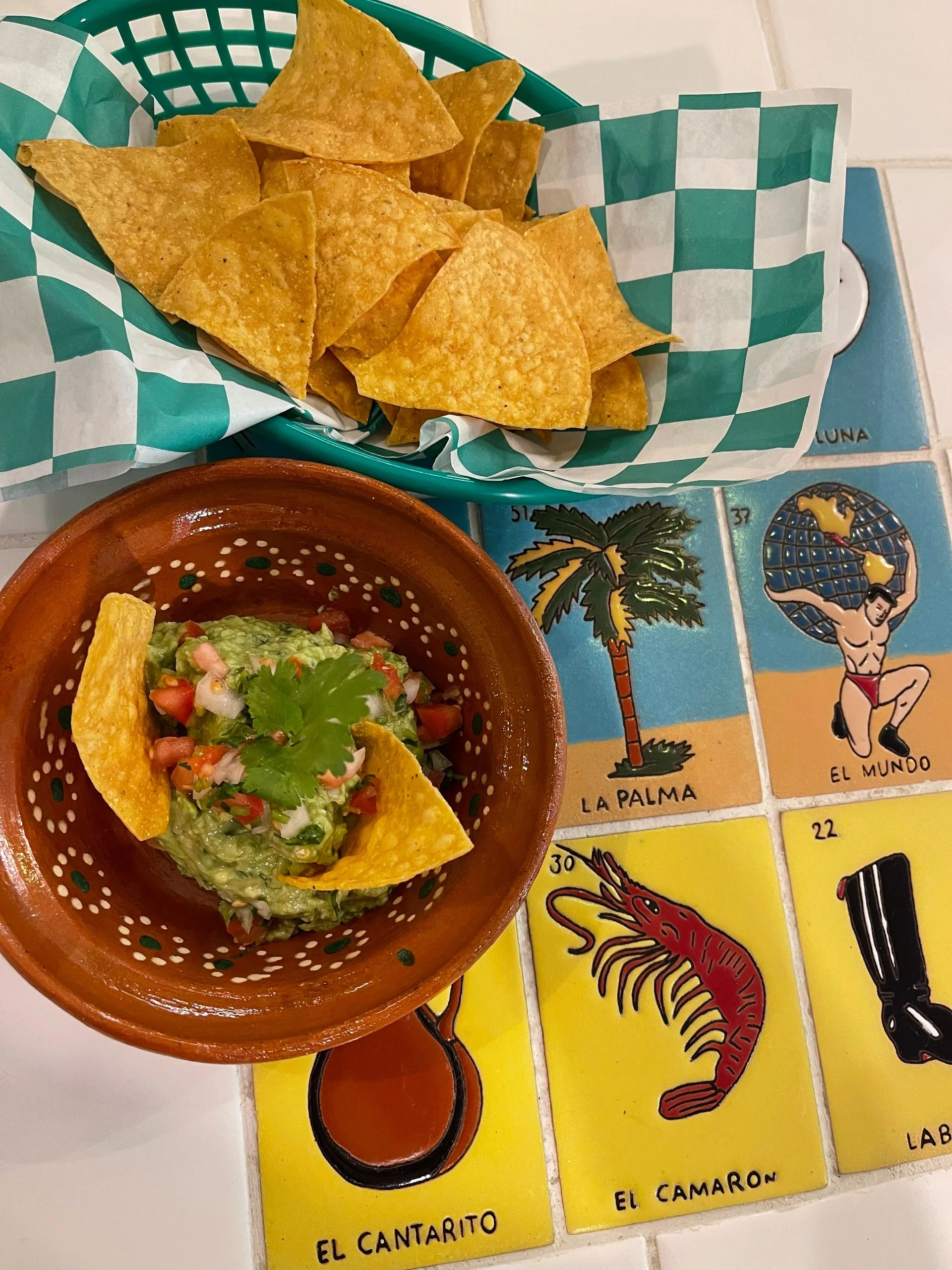 Fresh guacamole with tortilla chips in a vibrant Mexican setting
