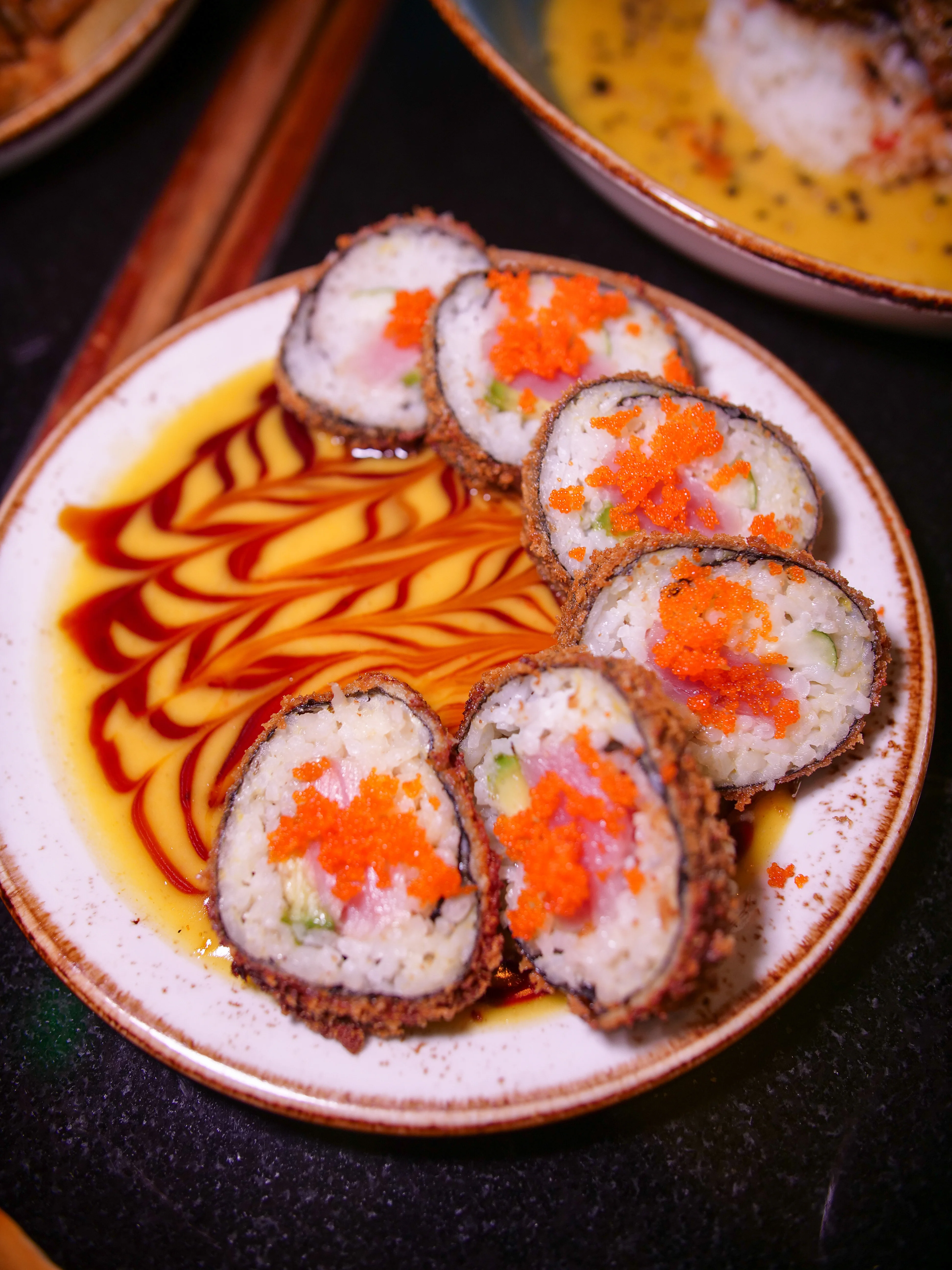 Crispy Japanese sushi rolls with spicy toppings