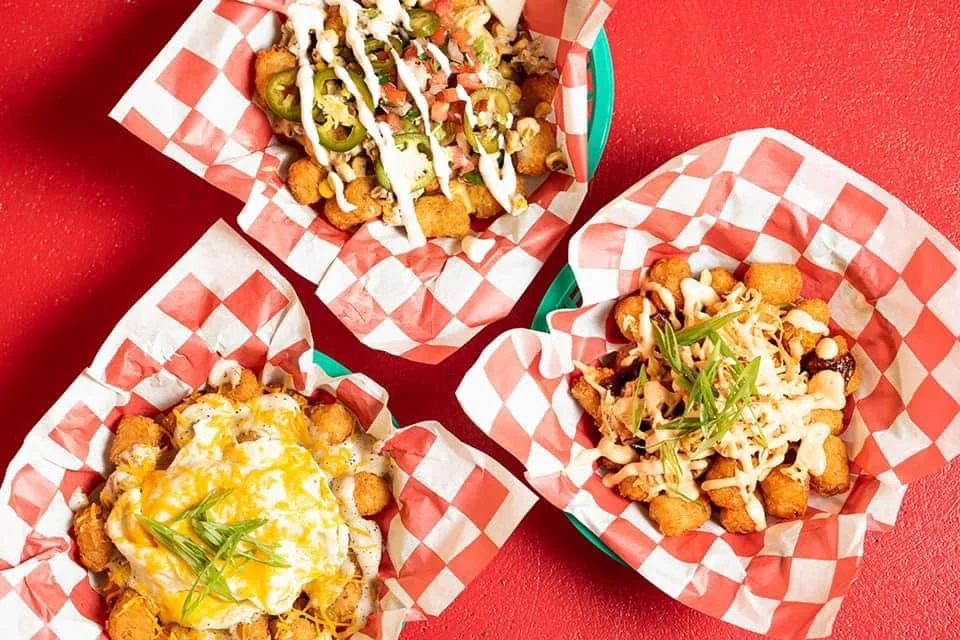 Loaded tater tots with toppings in a vibrant setting