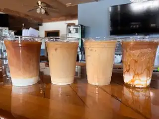 4 different cold brew coffee drinks on a bar