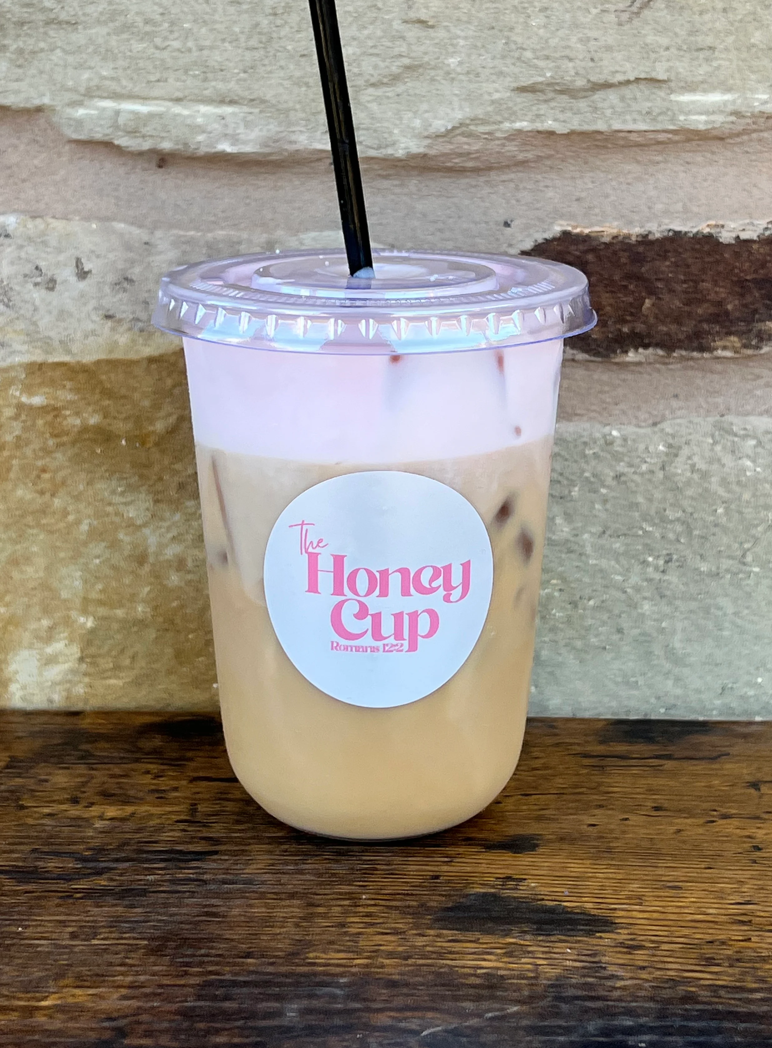 Iced honey milk tea in a clear cup